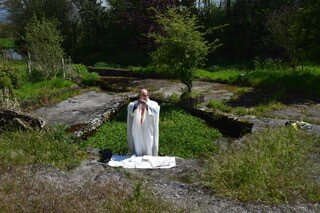 Fr Mark Condon celebrates Mass among rocks in a garden