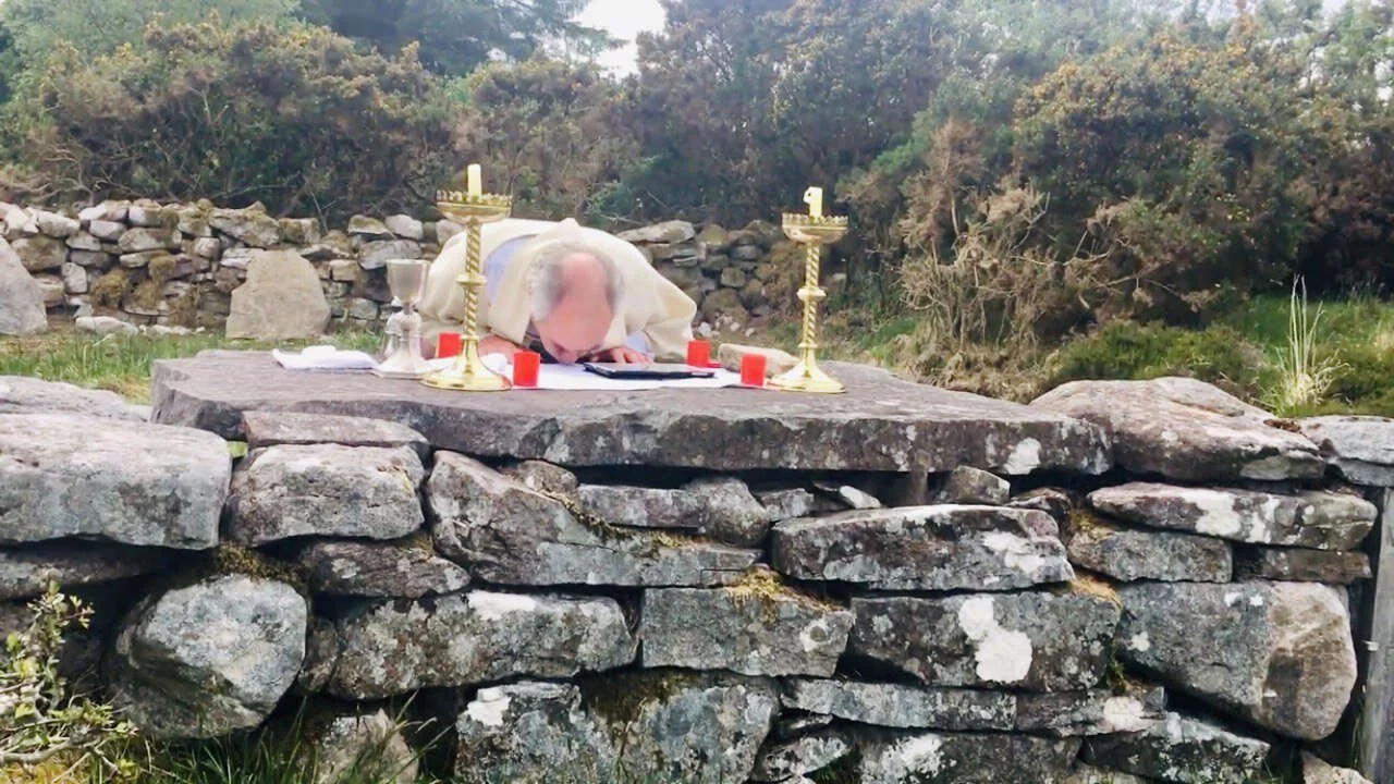 Fr Kieran O’Rourke bows over the altar at Loughatorick Mass Rock