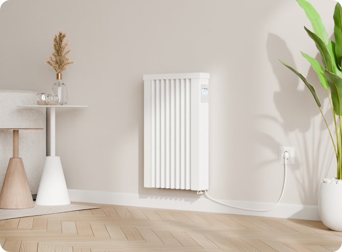 A white radiator mounted on a beige wall in a modern, minimalistic living space with wooden flooring and a potted plant next to it.