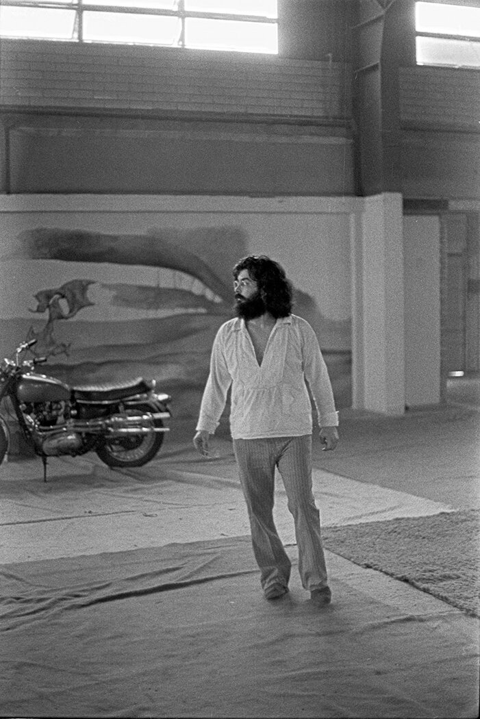 Eddie Wilson at the Armadillo World Headquarters with mural by Jim Franklin, 1972, photo by Van Brooks