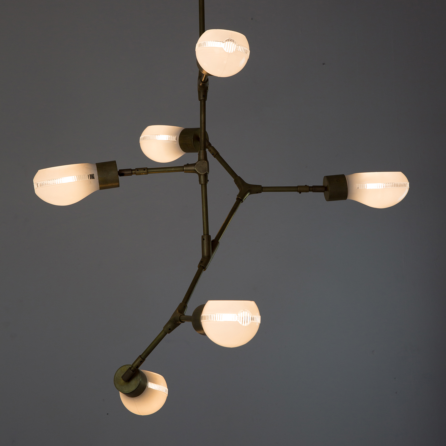 web222-6-Shades-Brass-Pendant-Model-02-lit-TJeannot-MarionFriedmannGallery.jpg