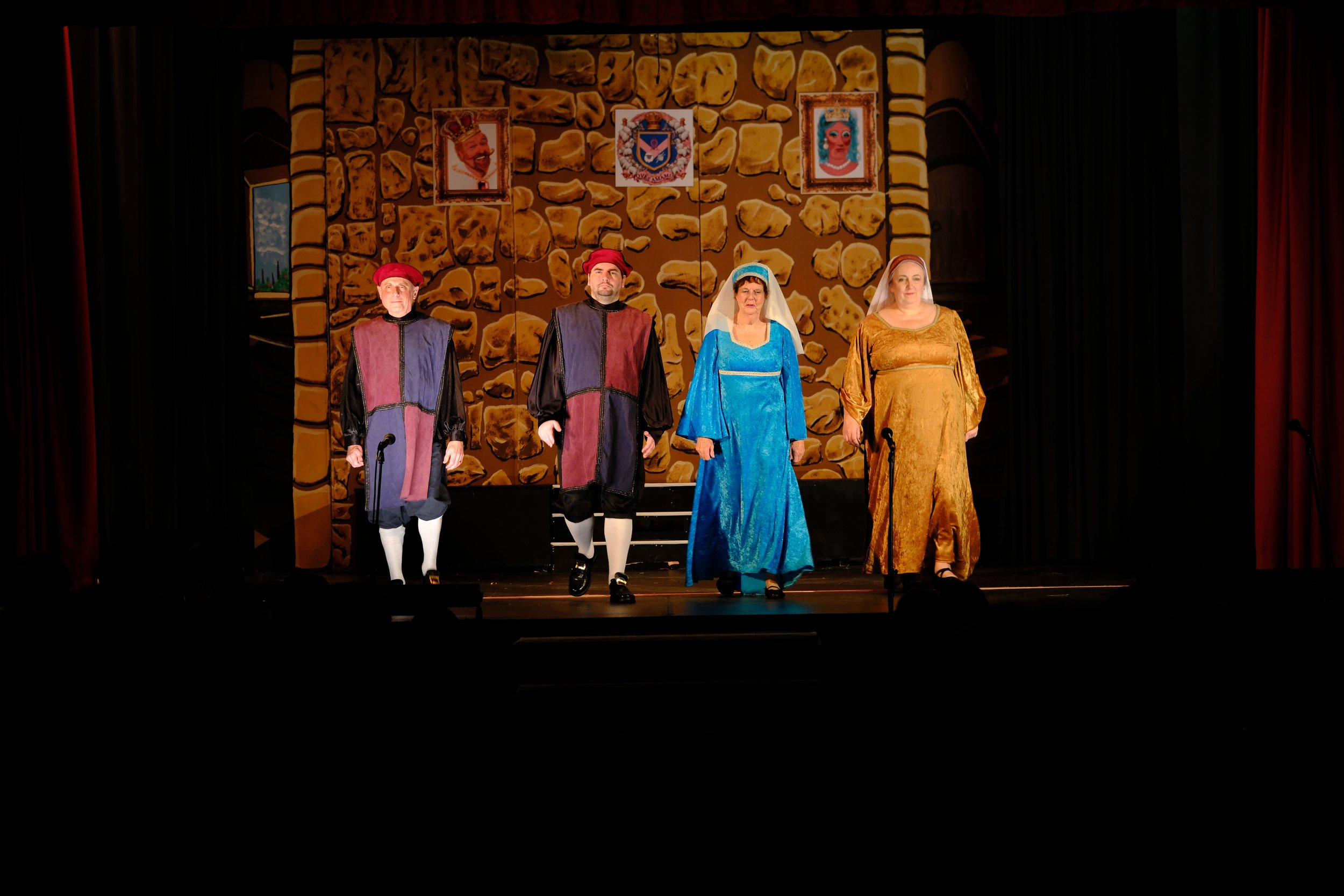 The palace backdrop with stairs, coat of arms with many sheep and two horrible caricatures of two cast members playing the king and queen!