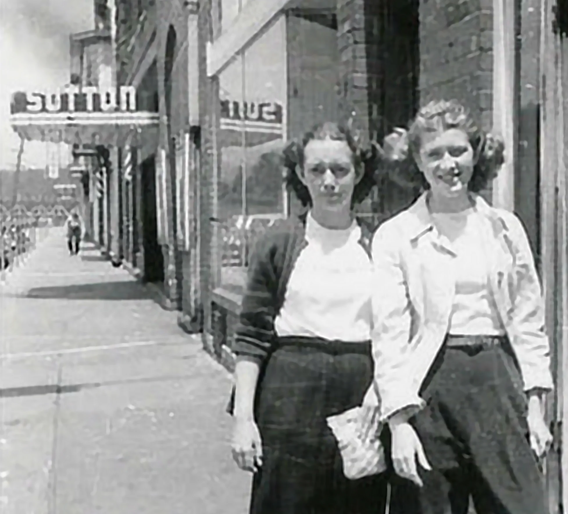 Local residents outside Sutton Theater in Thomas. Note the marquee in the background (the marquee has been placed into storage for potential future restoration and reuse).