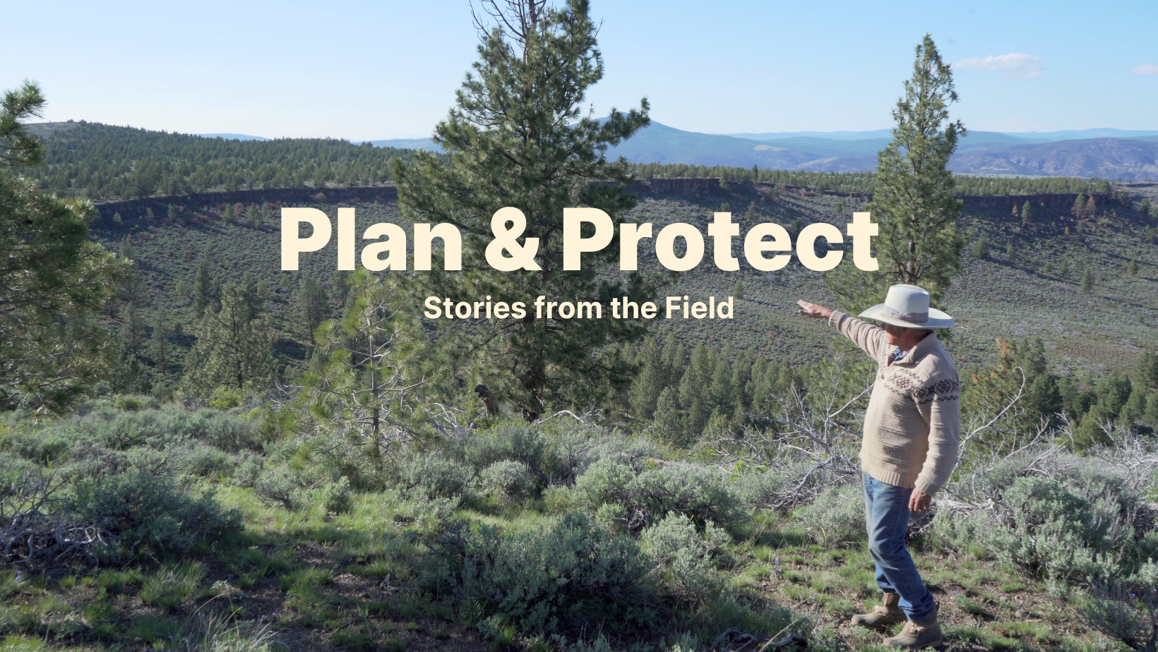 Rancher Jim Wood points across a landscape dotted with sagebrush and juniper toward the location of his working land easement at Aspen Valley Ranch.