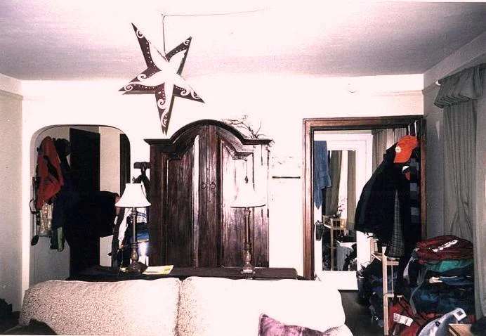 Old door to bedroom on right side. A typical Capitol Hill apartment where precious space is hard to find beneath a renter’s possessions.