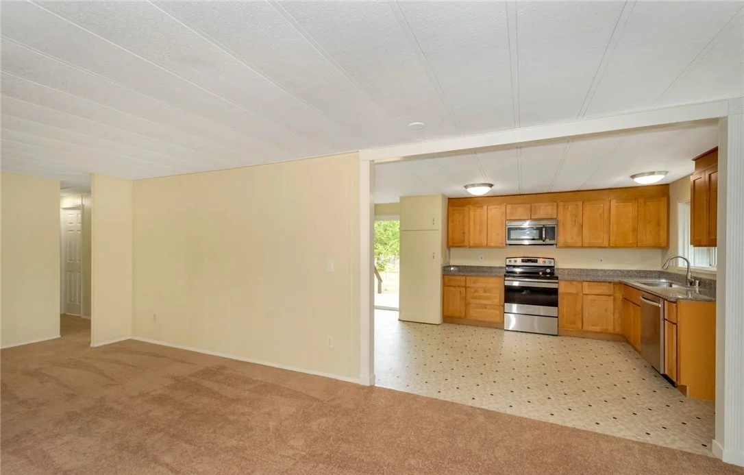View of widened opening between the kitchen and the dining room. A transfer beam was installed to carry the roof truss loads. Decorative trim was added around the opening for an inviting appearance.