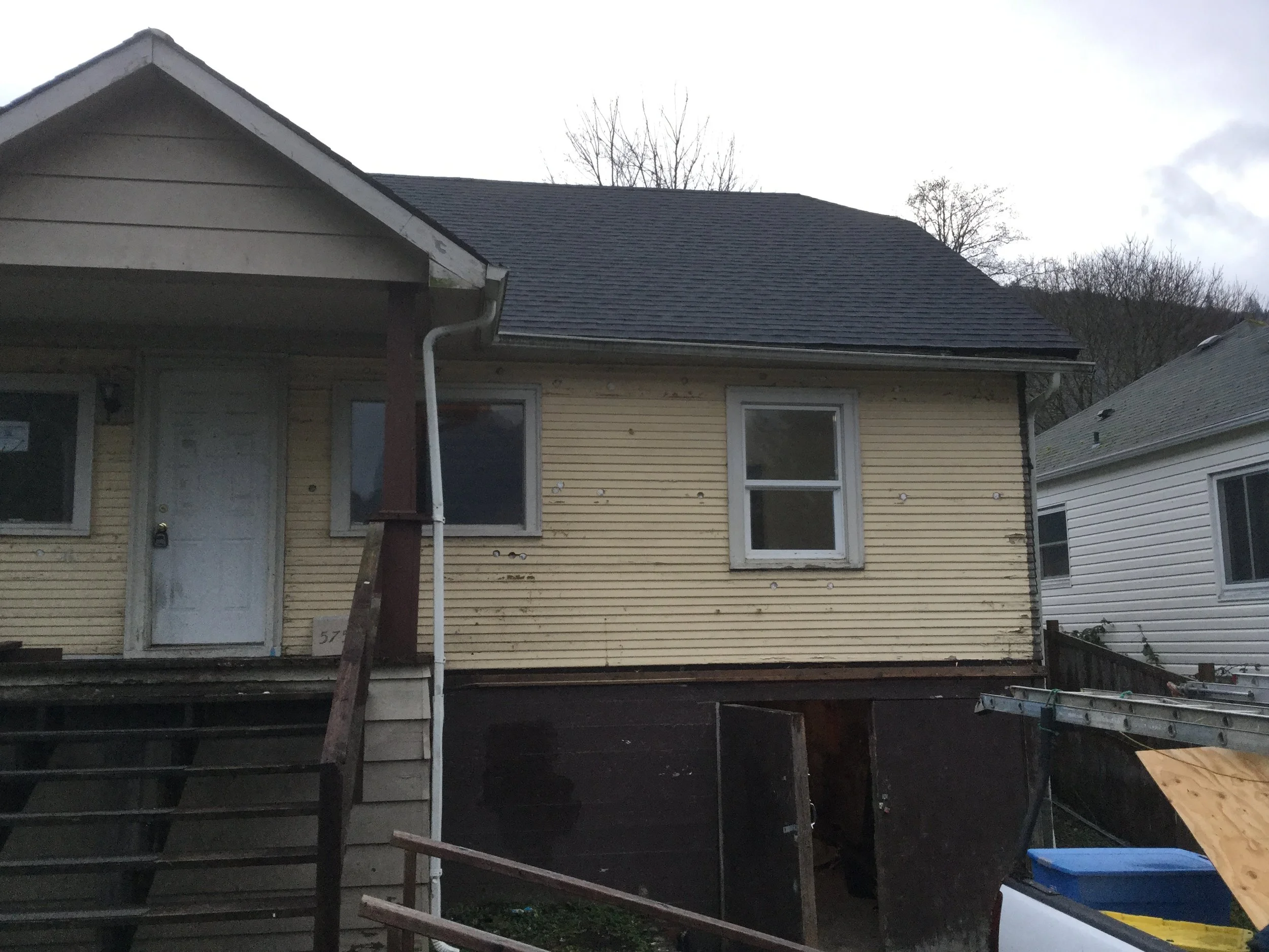 View of front of house after overlay siding removed.