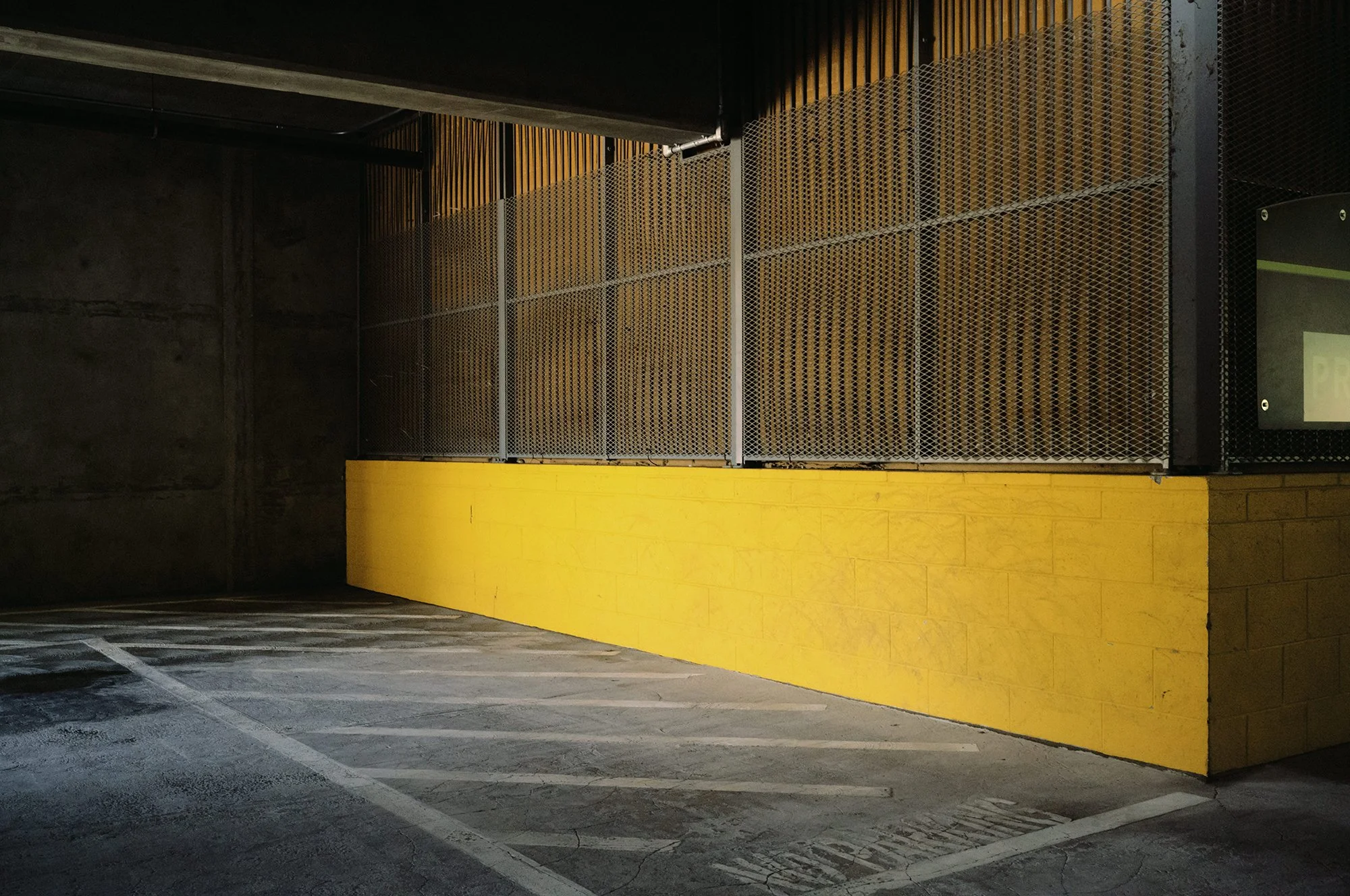 a bright yellow concrete section of an underground garage