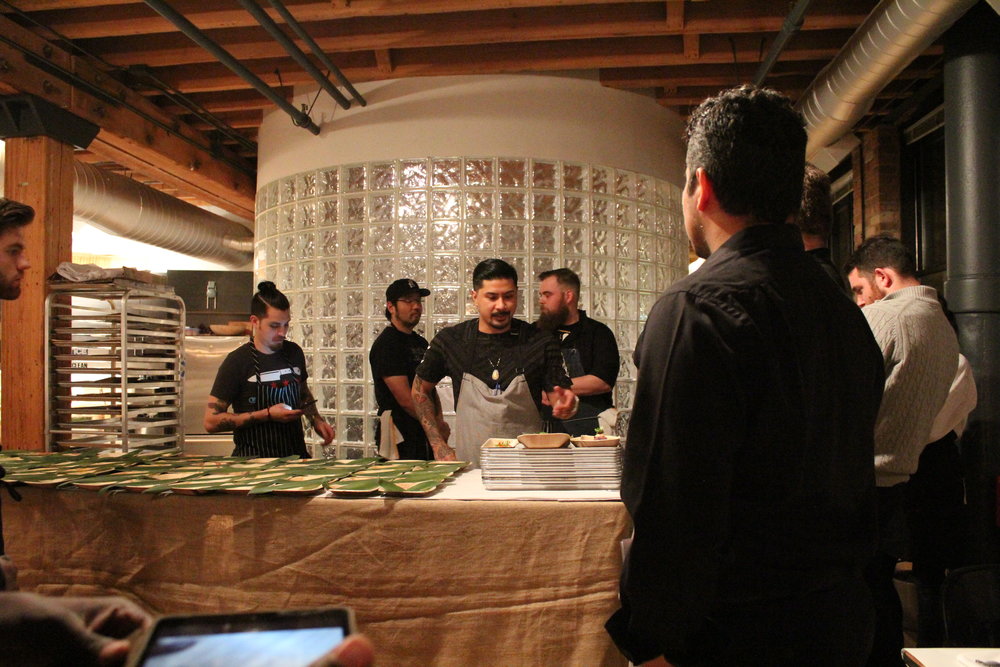 Chef Bryan (center) prepares cooks and servers for service with a run-through of the menu's finished plates. 