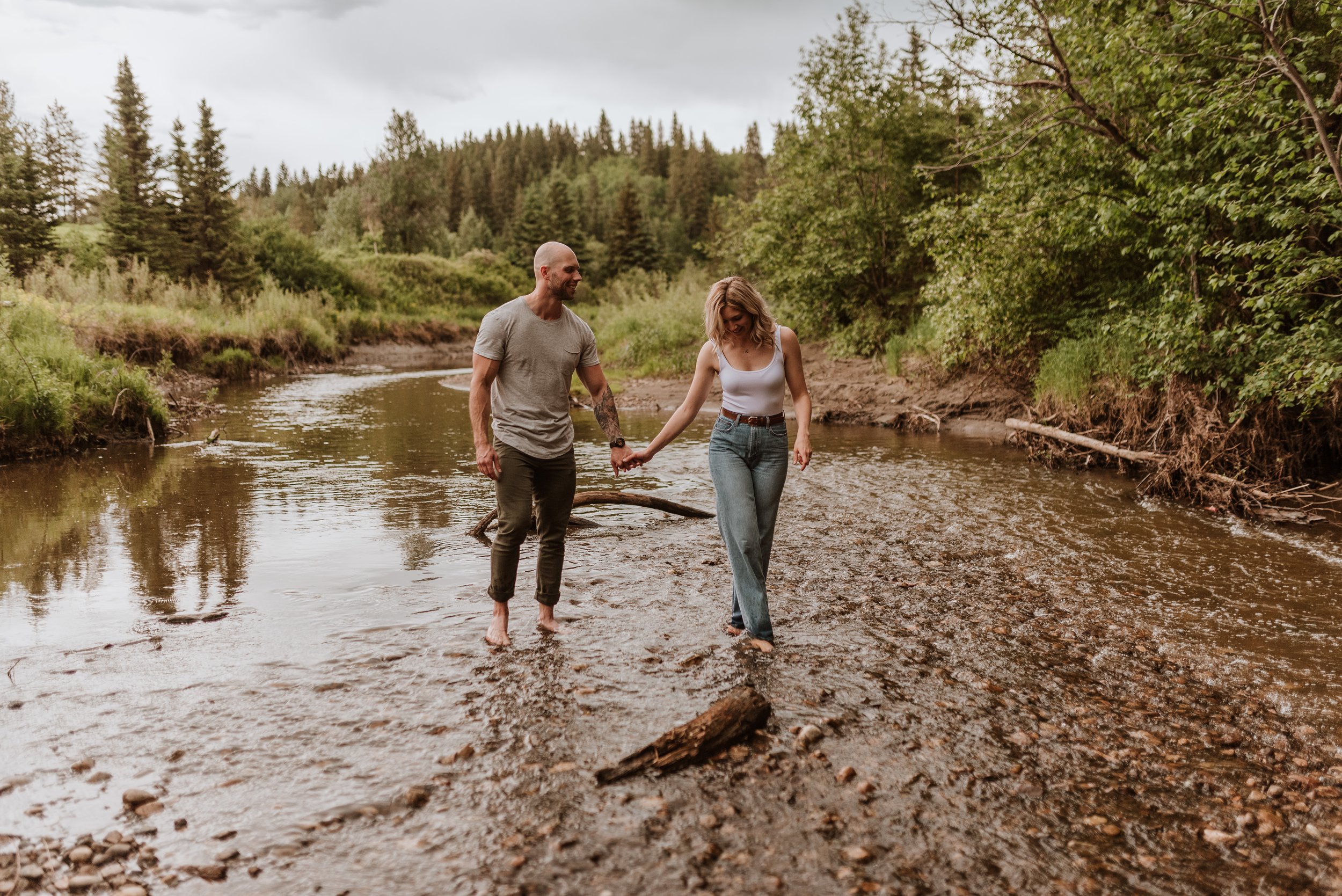 Couple walking in creek