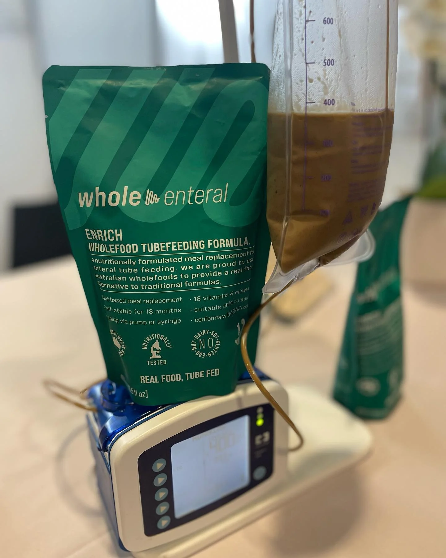 Pump or bolus? We have you covered with Enrich! 
#tubielife #tubiebaby #tubiemum #tubefeeding 
ID: image of a pouch of enrich sitting on top of a kangaroo pump.