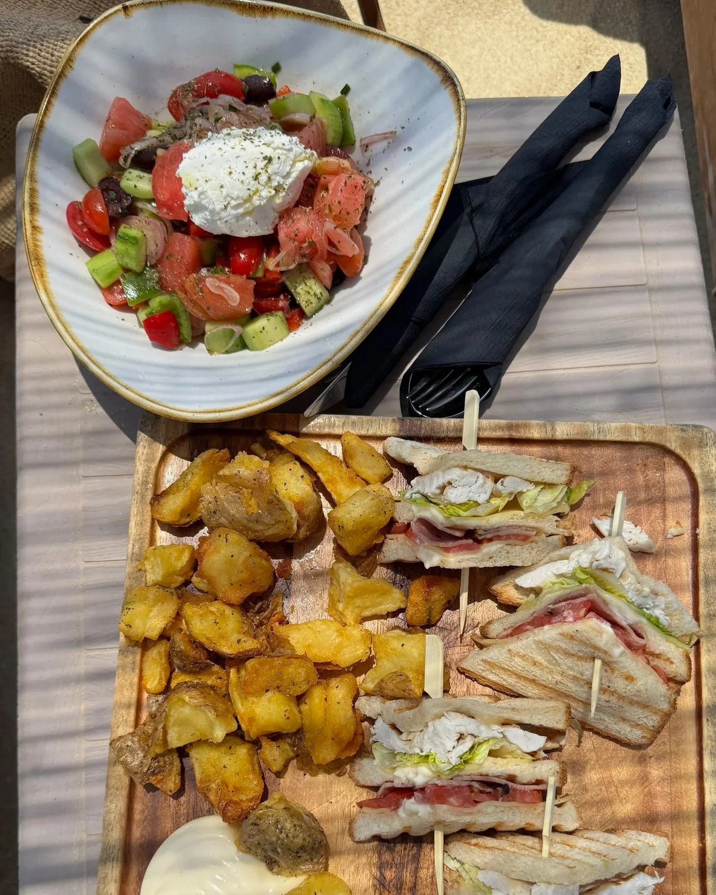 Club sandwich and Greek salad at a beach club on Plaka Beach, Naxos
