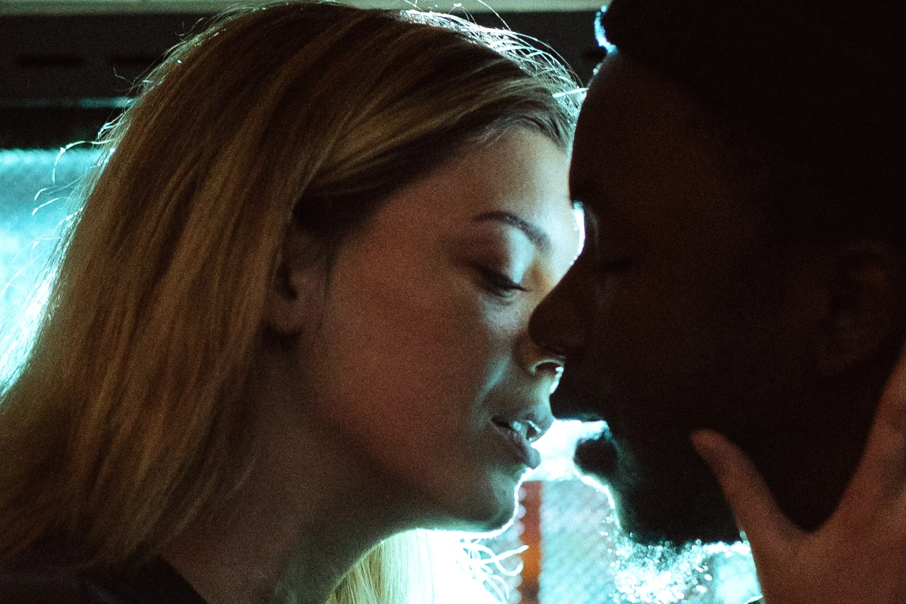 Interracial couple about to kiss.