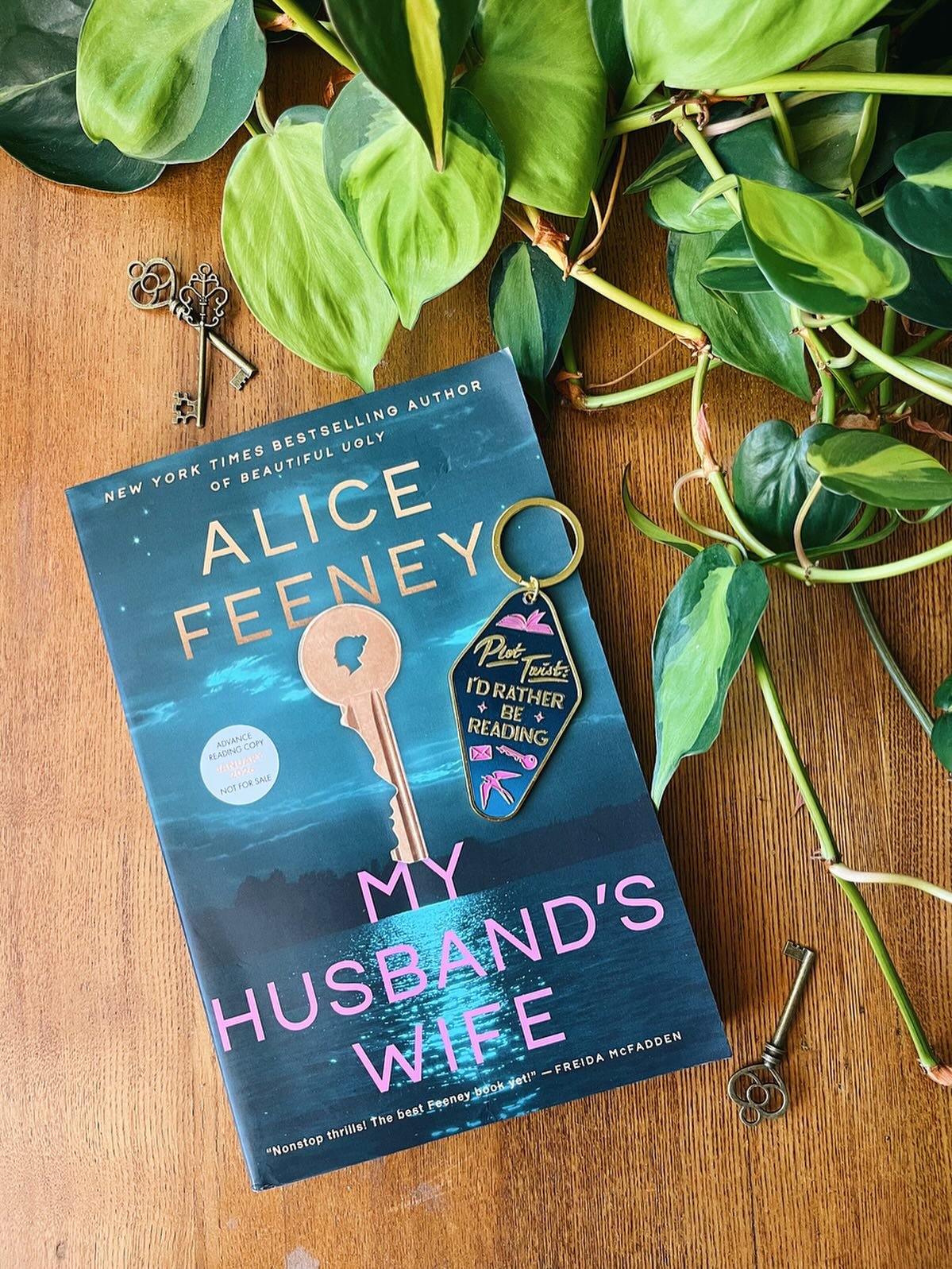 We *need* this keychain in our lives! You can get this when you preorder My Husband&rsquo;s Wife by @alicewriterland and sign up at the link in our bio before it goes on sale January 20, 2026. 

What are you waiting for?!