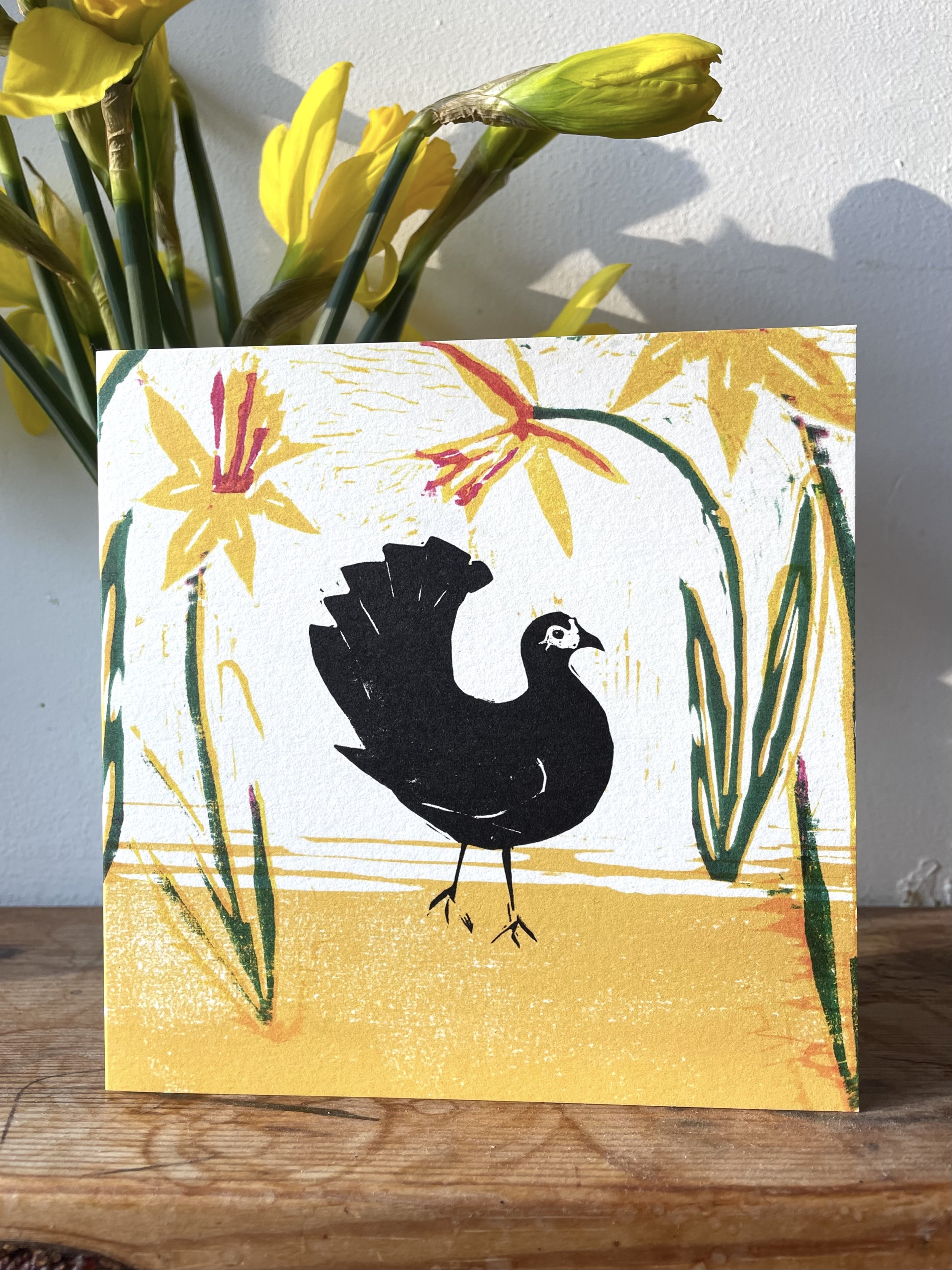 Linocut printed greetings card of a chicken and spring daffodils locally made in Bristol