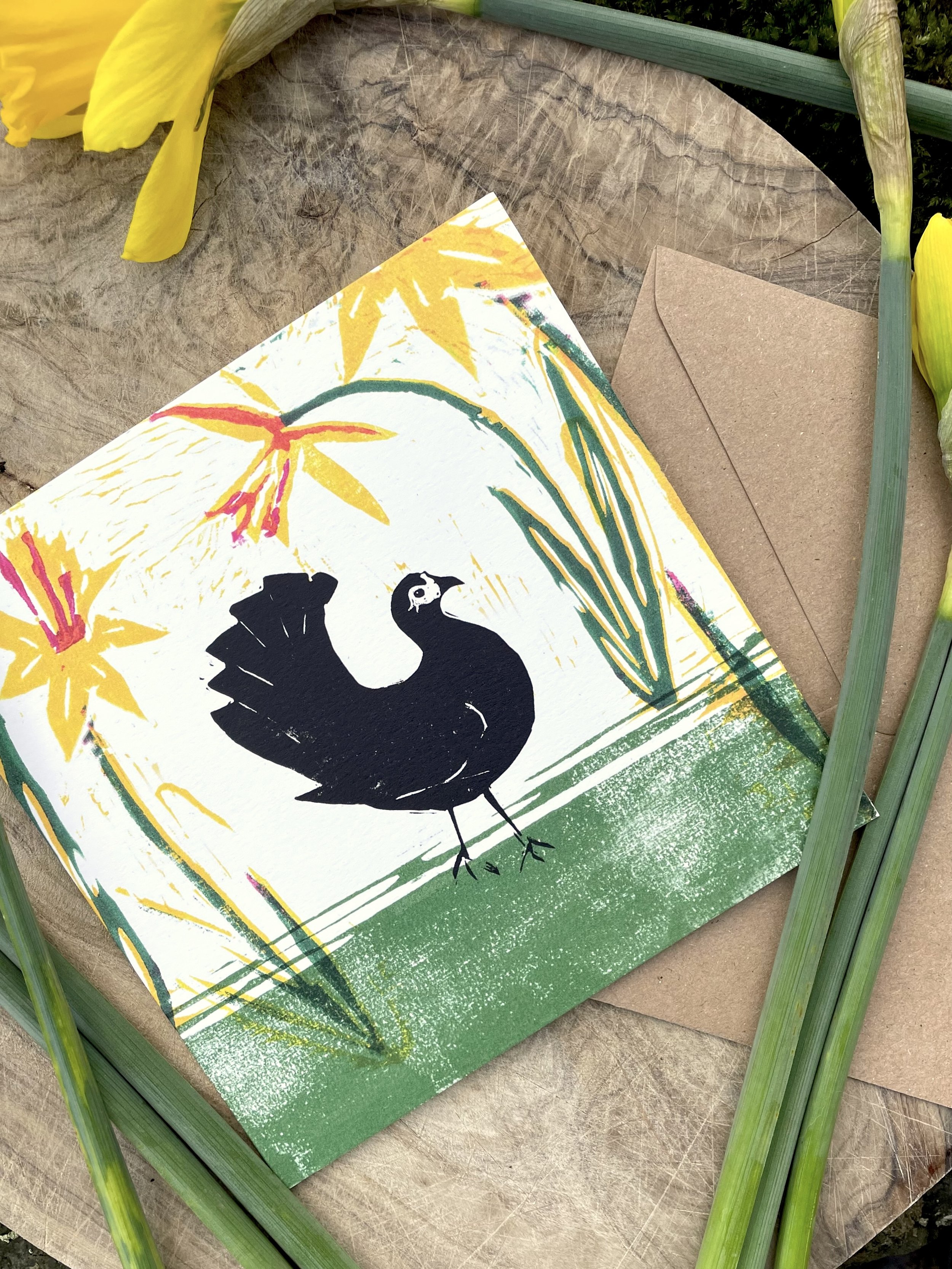 Linocut printed greetings card of a chicken and spring daffodils locally made in Bristol