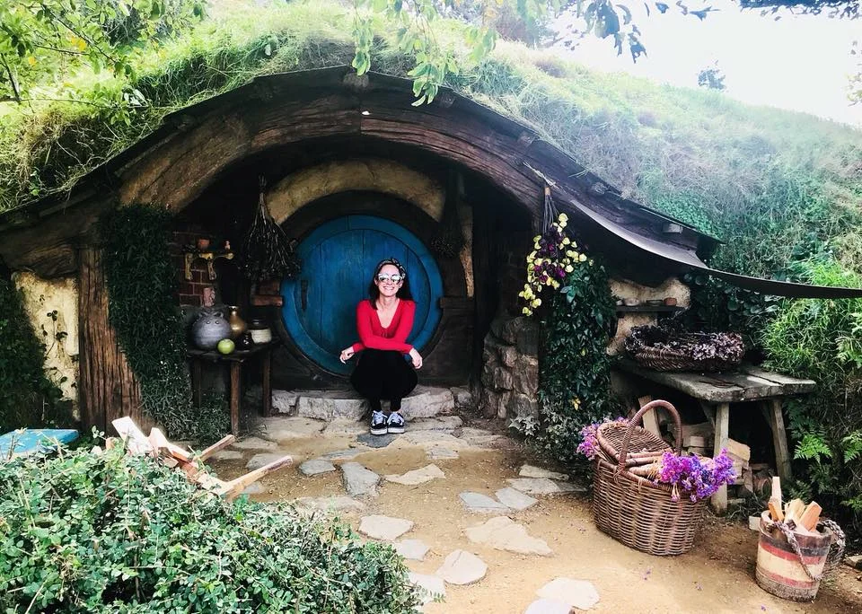 Sam showing off the tiny hobbit holes at Hobbiton.