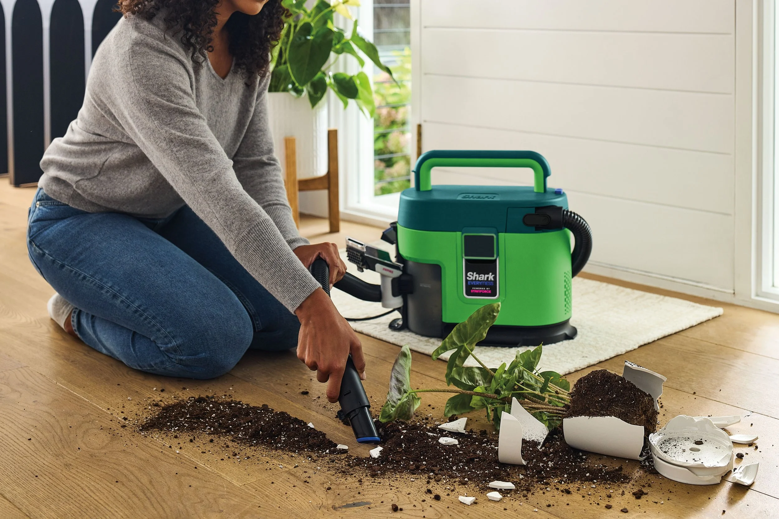 JPG-R_VX100_InUse_AbvFlr_Entryway_HardFloor_Woman_plant.jpg