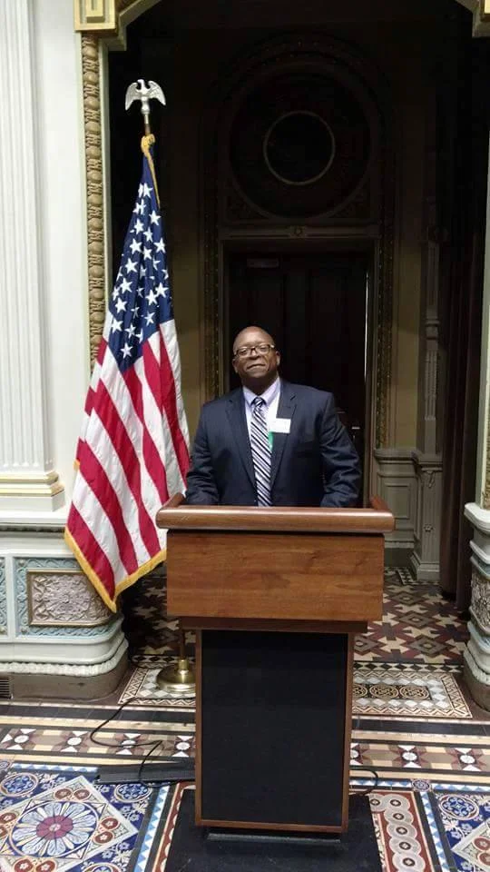 CoachDerrickPearsonnext to americanFlag_n.jpg