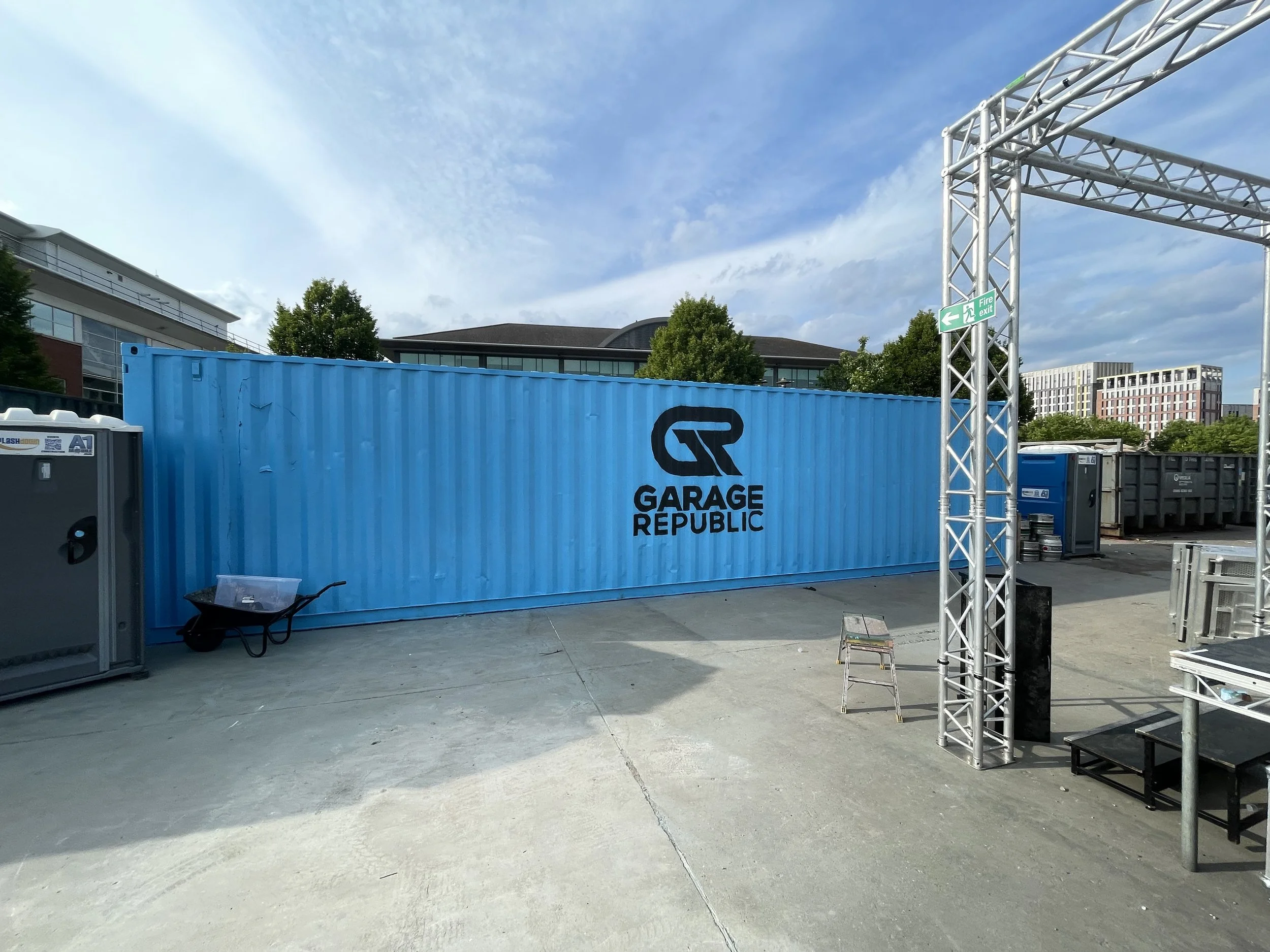 "Vibrant mural on shipping containers in Nottingham, showcasing bold geometric patterns and dynamic street art by local mural painter."