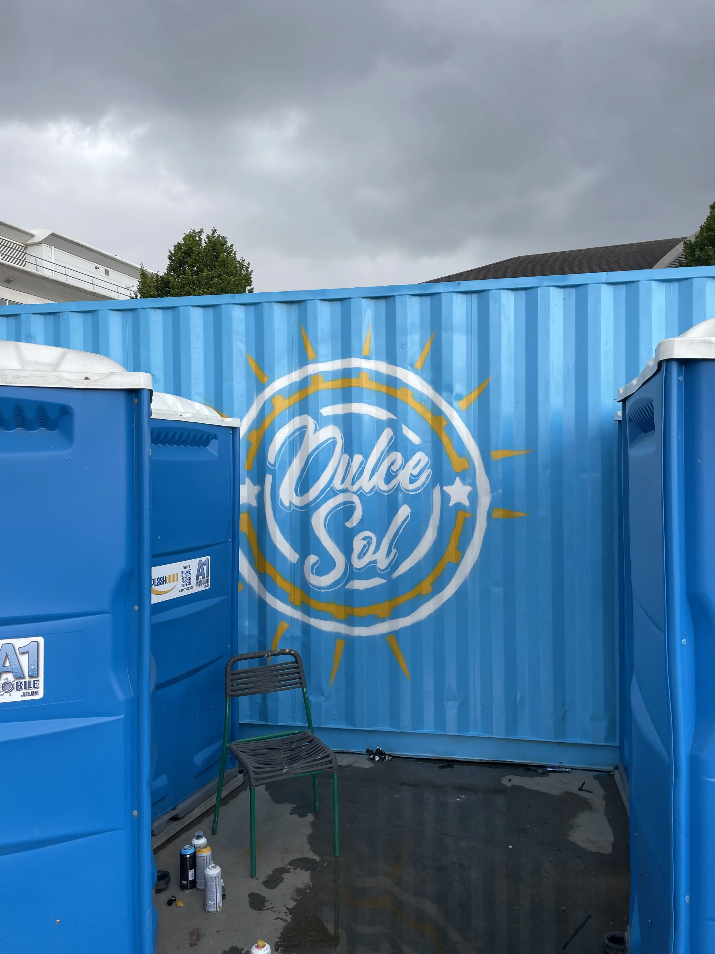 Vibrant mural on shipping containers in Nottingham, showcasing bold geometric patterns and dynamic street art by local mural painter