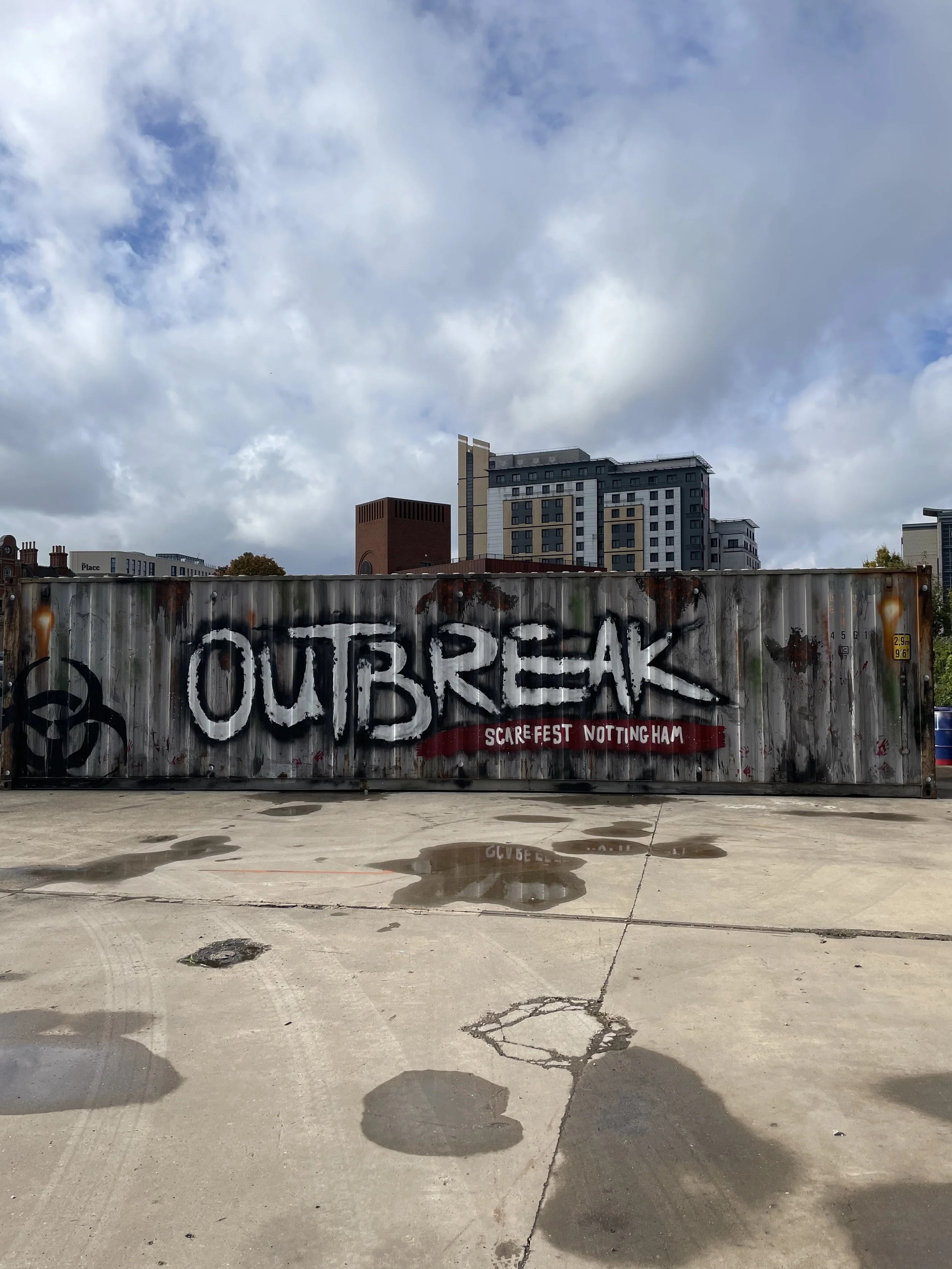Vibrant mural on shipping containers in Nottingham, showcasing bold geometric patterns and dynamic street art by local mural painter  kaption1