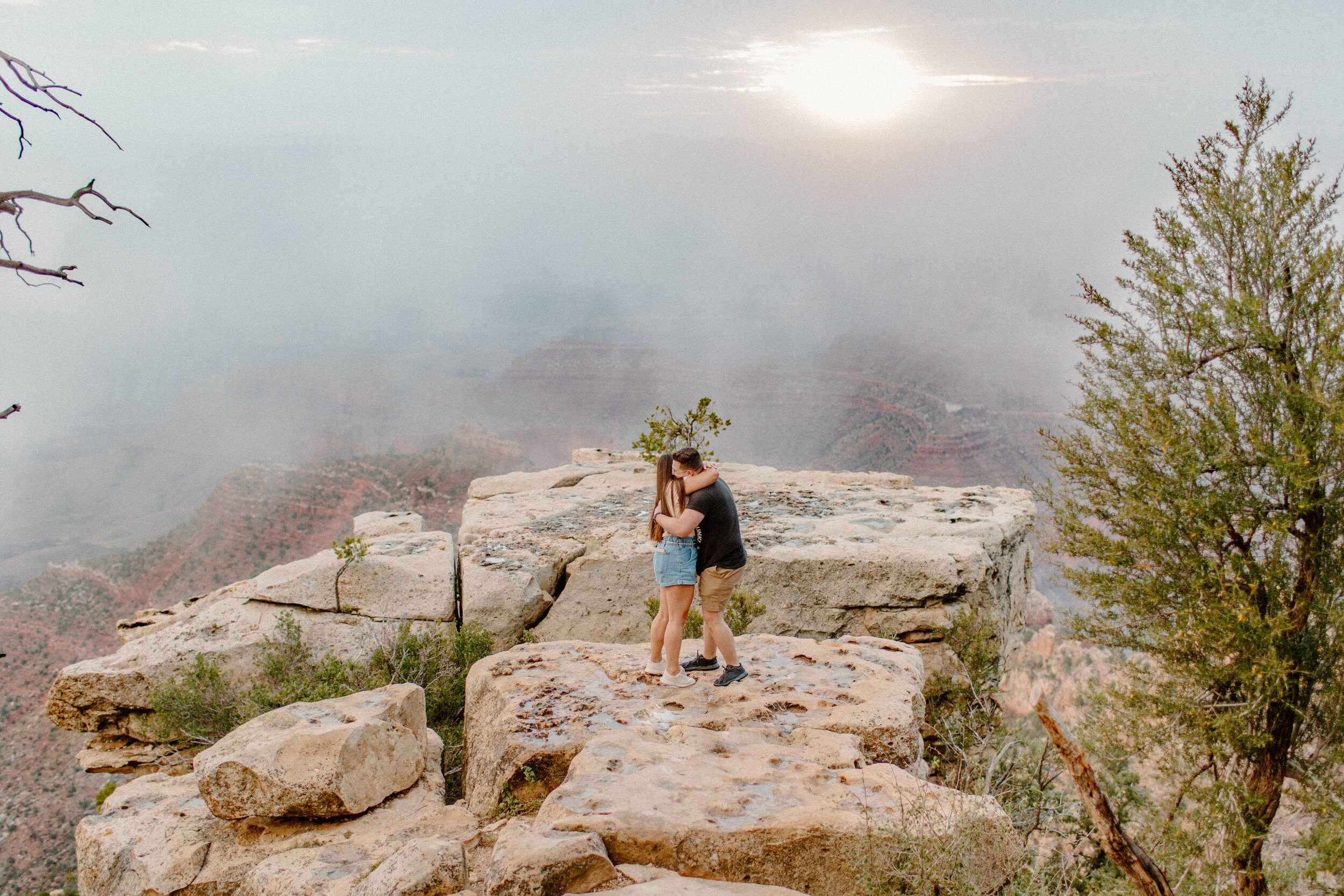  Surprise proposal at sunrise at the Grand Canyon. Couple hugs each other after the man proposed to the woman at the rim of the Grand Canyon at Grandview Point. Grand Canyon engagement, Lucy B. Photography. 