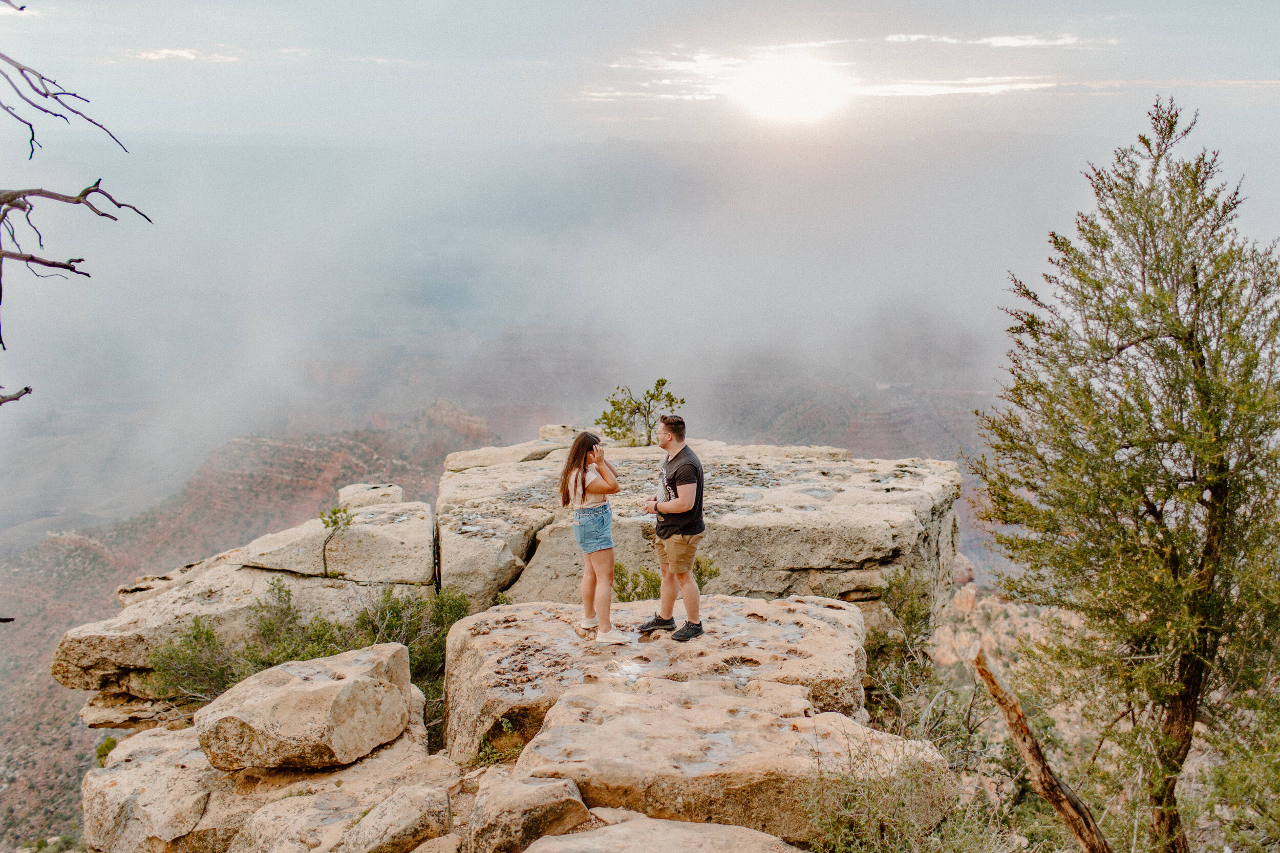  Surprise proposal at sunrise at the Grand Canyon. Woman reacts happily to her boyfriend proposing to her at the rim of the Grand Canyon at Grandview Point. Grand Canyon engagement, Lucy B. Photography. 