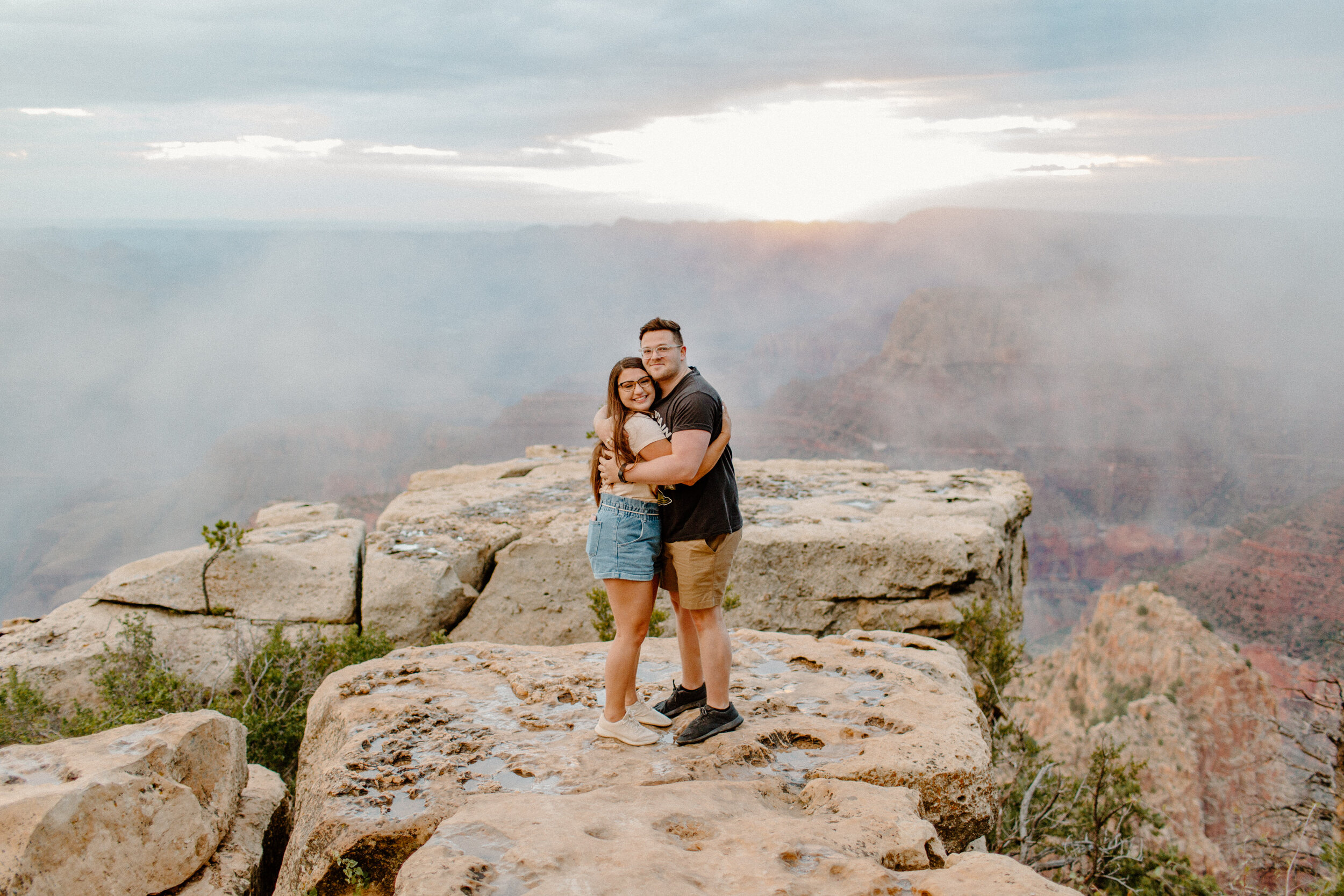  Surprise proposal at sunrise at the Grand Canyon. Couple holds each other and smiles at the camera after becoming engageed at the rim of the Grand Canyon at Grandview Point. Grand Canyon engagement, Lucy B. Photography. 