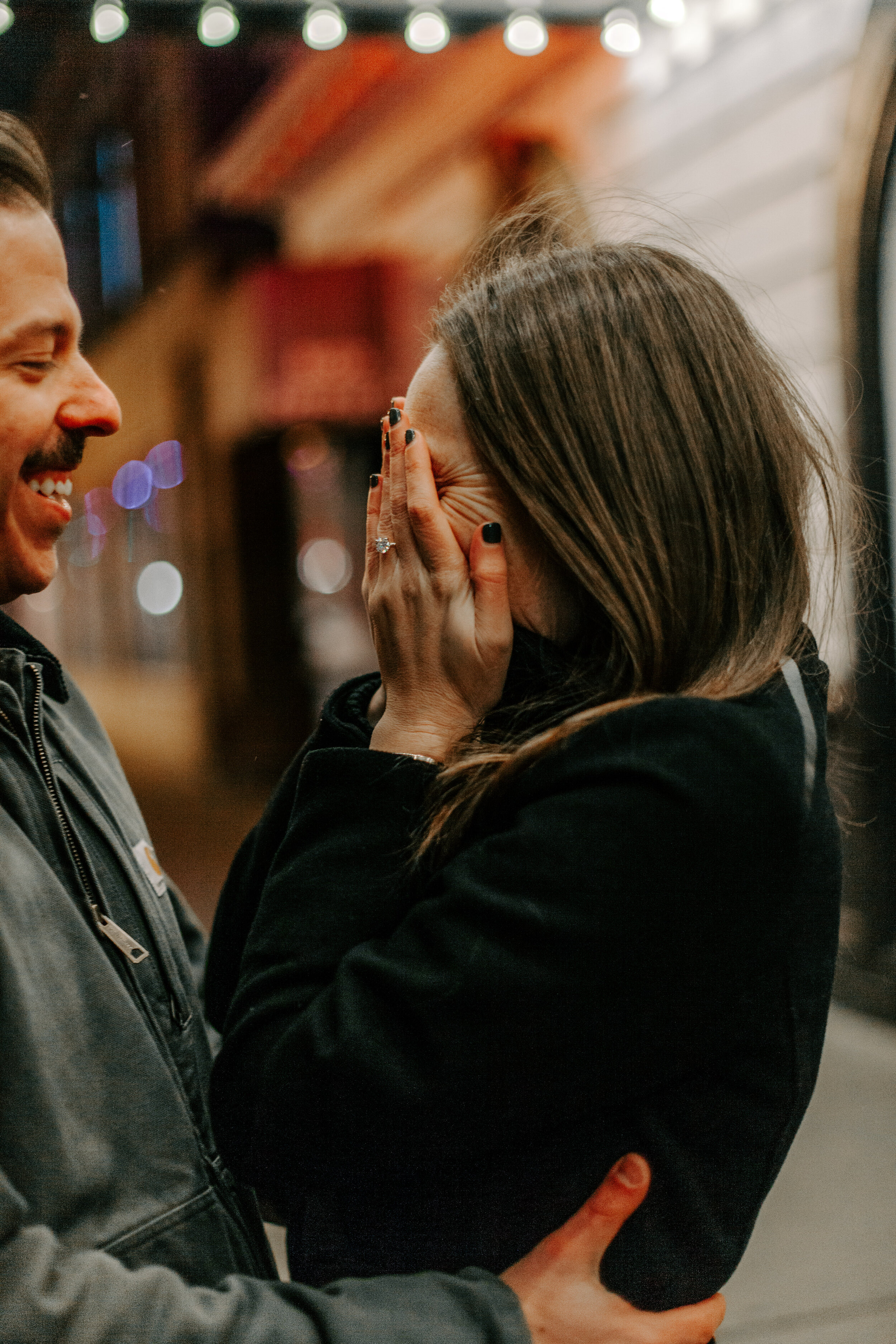  Chicago surprise proposal, woman emotionally puts her hands over her face after being proposed to, showing off her new engagement ring as her fiancee holds her. Chicago engagement photographer, Lucy B. Photography 