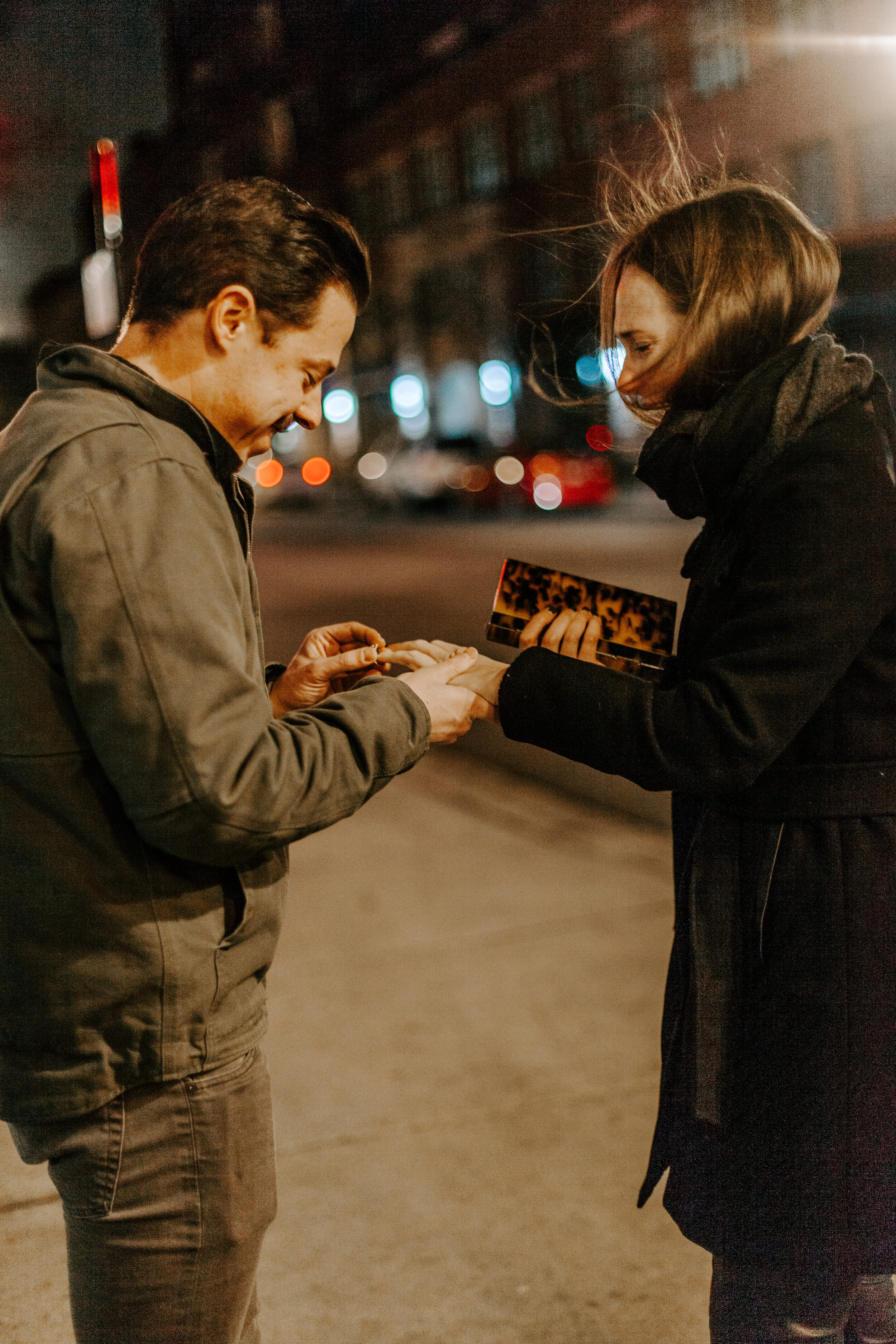  Chicago surprise proposal, man puts engagement ring on his new fiance’s finger as she reacts emotionally and happily. Chicago engagement photographer, Lucy B. Photography 