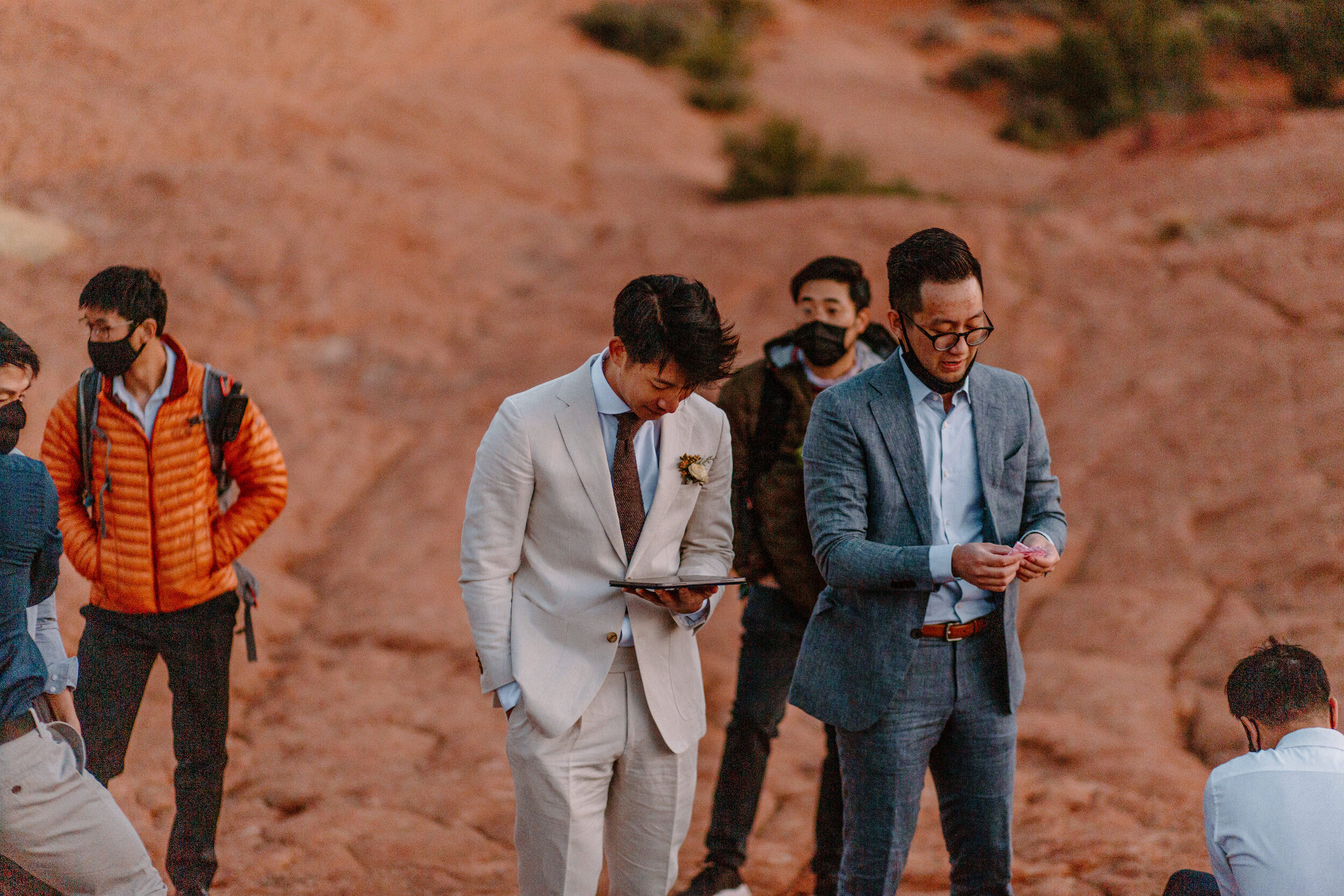  Groom reviews his vows with his groomsmen at Snow Canyon State Park in St. George Utah. Utah elopement photographer, Lucy B. Photography. 