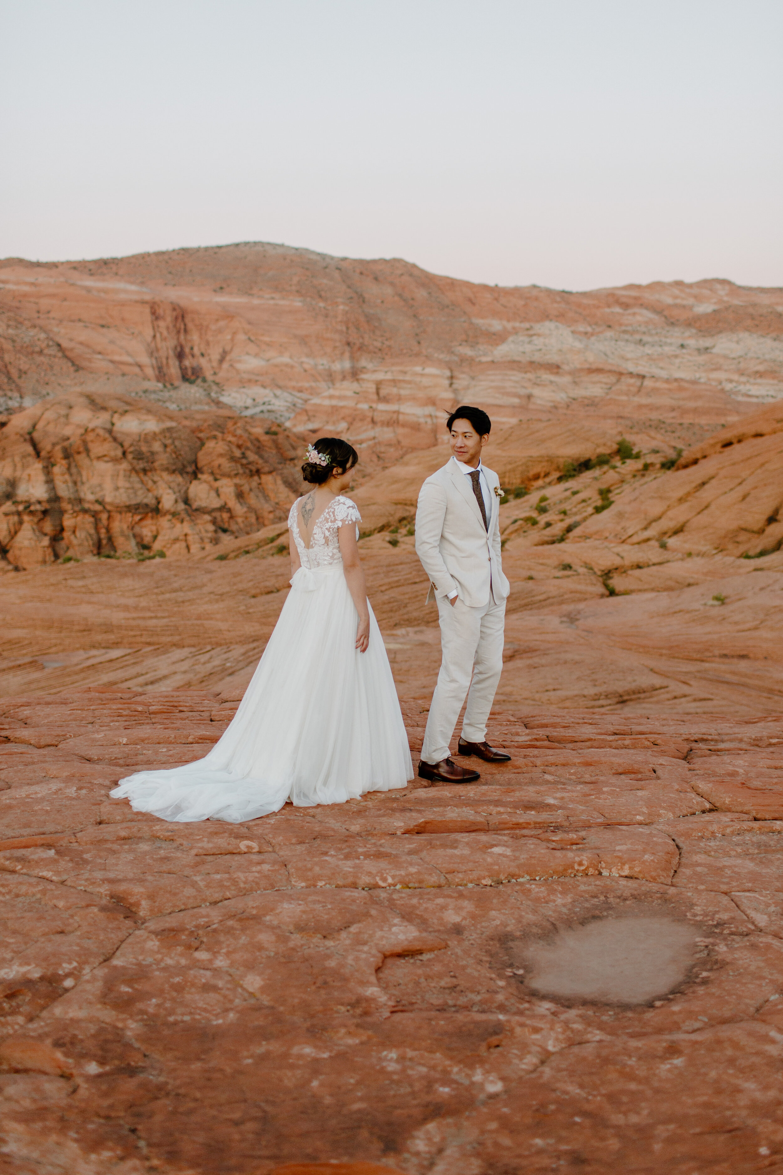  Groom turns around to see his bride during first look at Snow Canyon State Park in St. George Utah. Utah elopement photographer, Lucy B. Photography. 