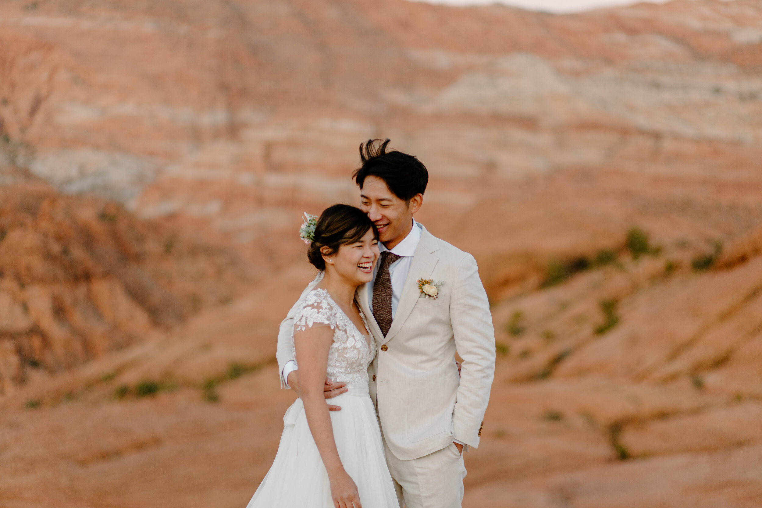  Bride and groom hug and laugh after doing their first look at Snow Canyon State Park in St. George Utah. Utah elopement photographer, Lucy B. Photography. 
