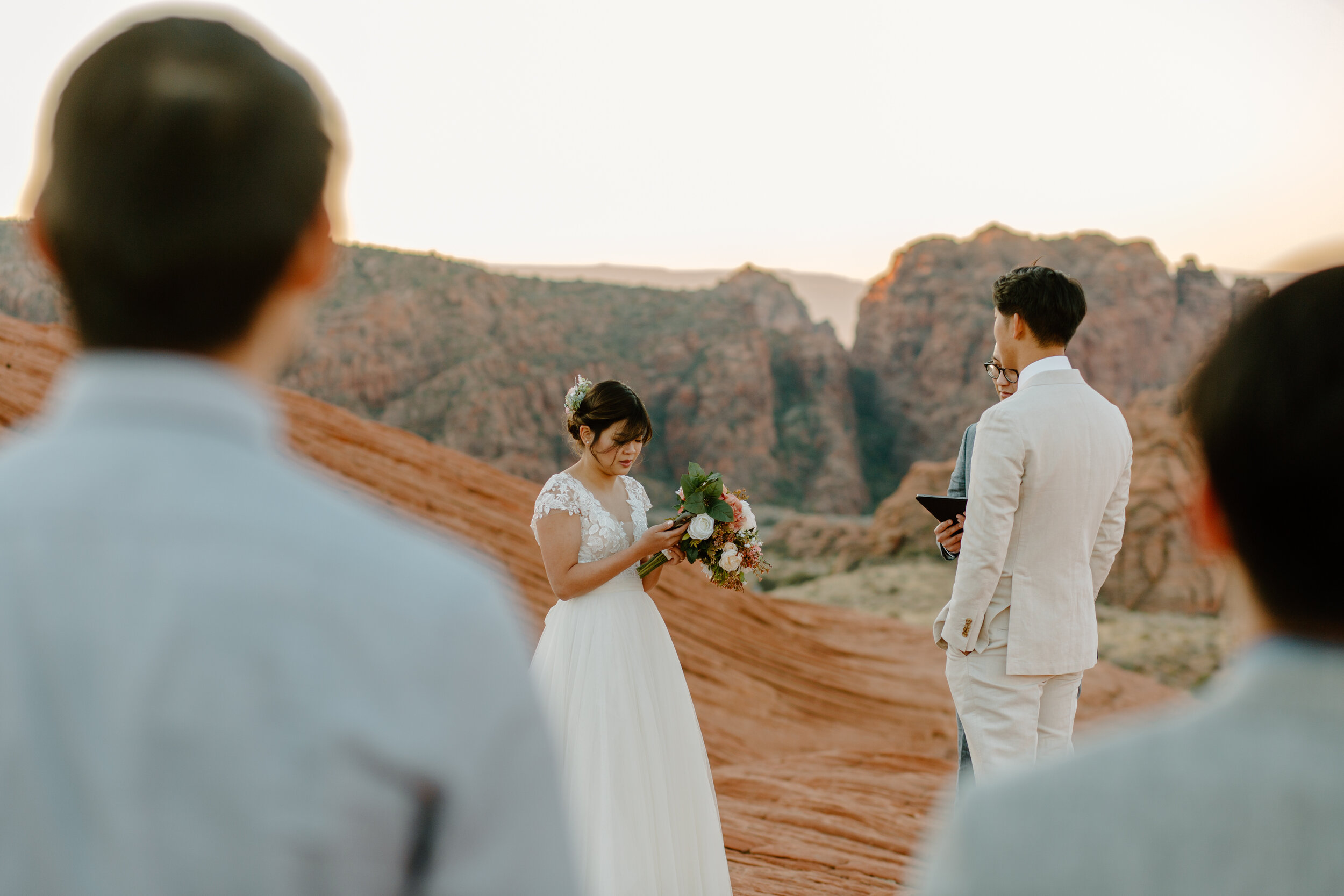  Bride reads her vows to her groom at their Utah elopement at Snow Canyon State Park in St. George Utah. Utah elopement photographer, Lucy B. Photography. 