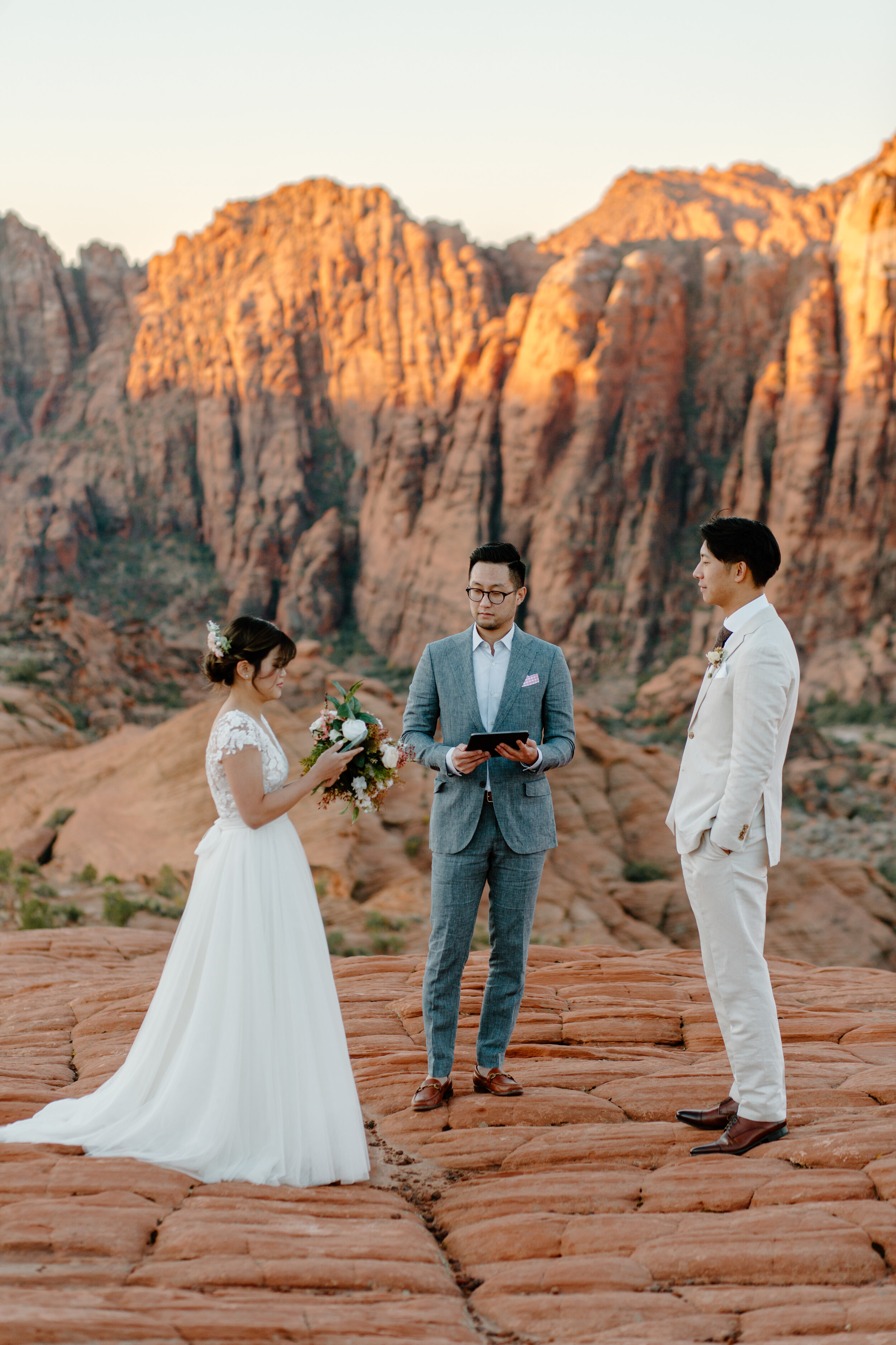  Bride reads her vows to her groom during their Utah elopement at Snow Canyon State Park in St. George Utah. Utah elopement photographer, Lucy B. Photography. 