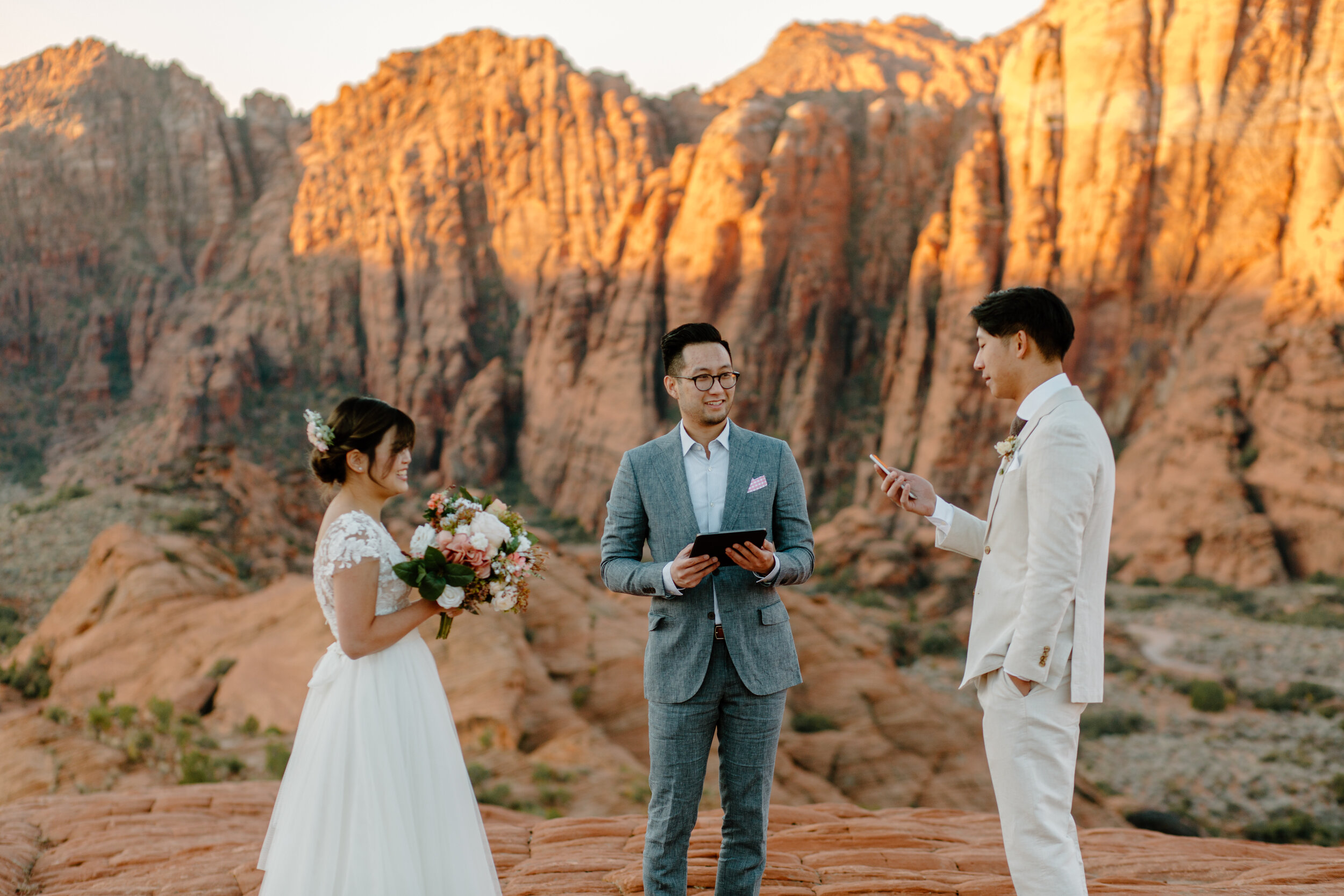  Groom reads his vows to his bride during their Utah elopement at Snow Canyon State Park in St. George Utah. Utah elopement photographer, Lucy B. Photography. 