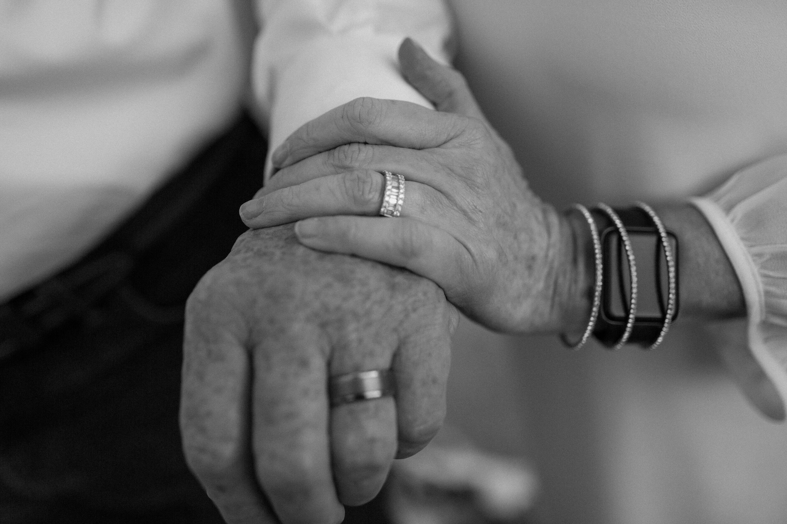  Black and white close up photo of bride and groom’s hands with their new wedding bands after their elopement in Catalina State Park in Tucson. Tucson elopement photographer, Lucy B. Photography. 
