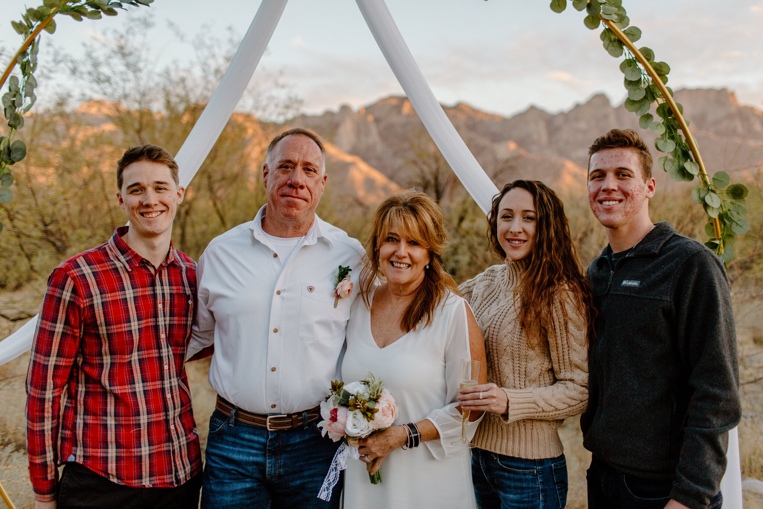  Group photo of elopement couple with the groom’s 3 young adult kids in Catalina State Park in Tucson. Tucson elopement photographer, Lucy B. Photography. 