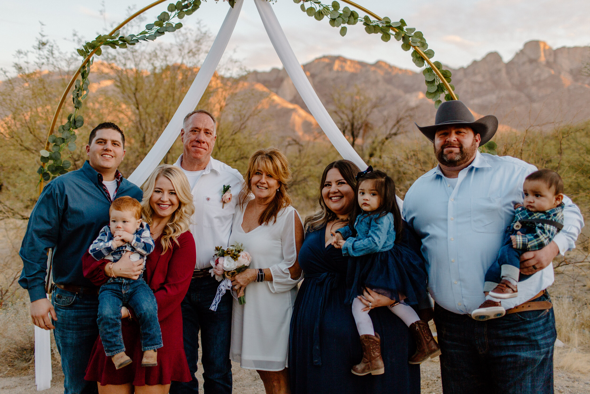  Group photo of elopement couple with the bride’s kids, their spouses, and her grandkids in Catalina State Park in Tucson. Tucson elopement photographer, Lucy B. Photography. 