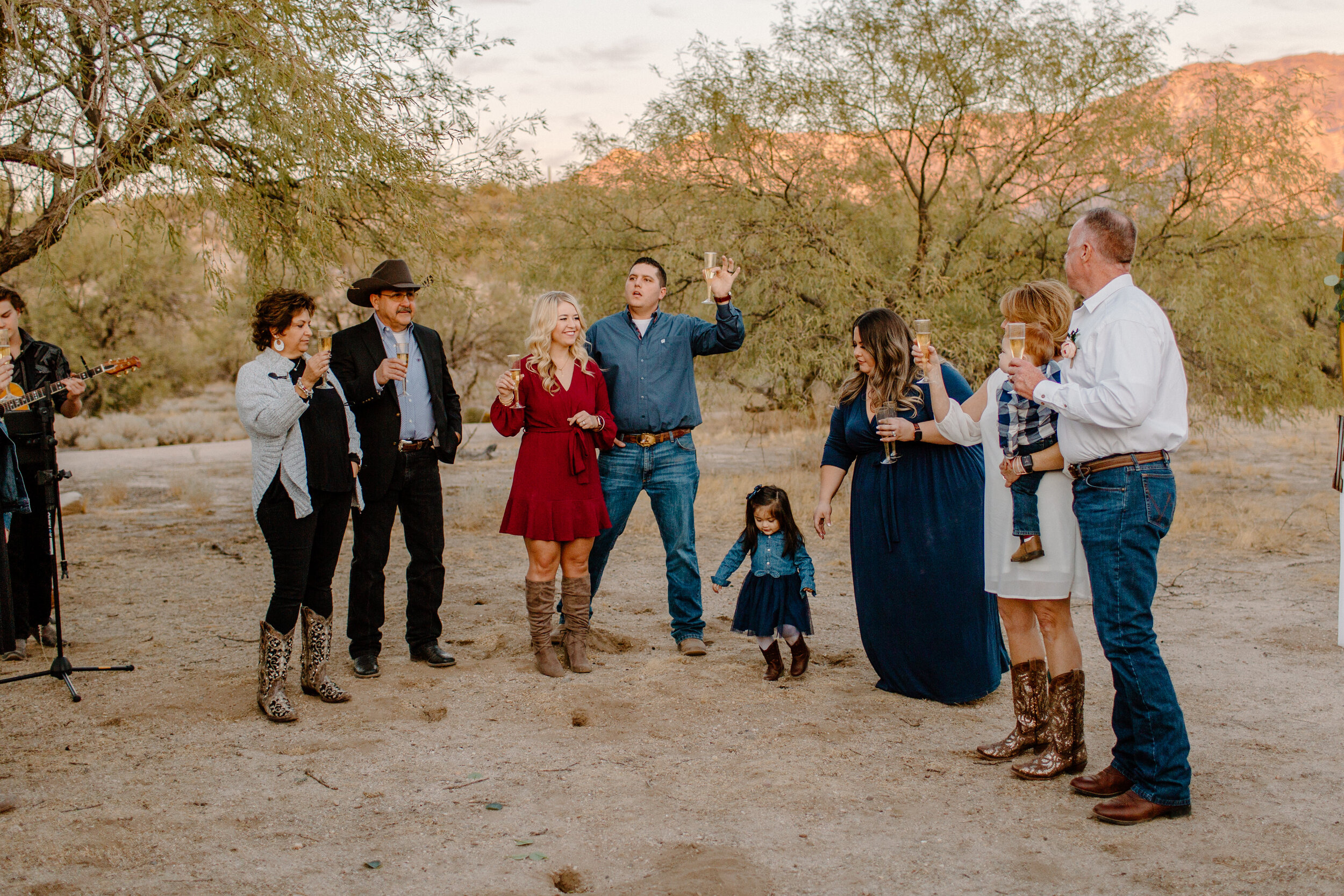  Family raises a toast to newly married couple after their elopement ceremony in Catalina State Park in Tucson. Tucson elopement photographer, Lucy B. Photography. 