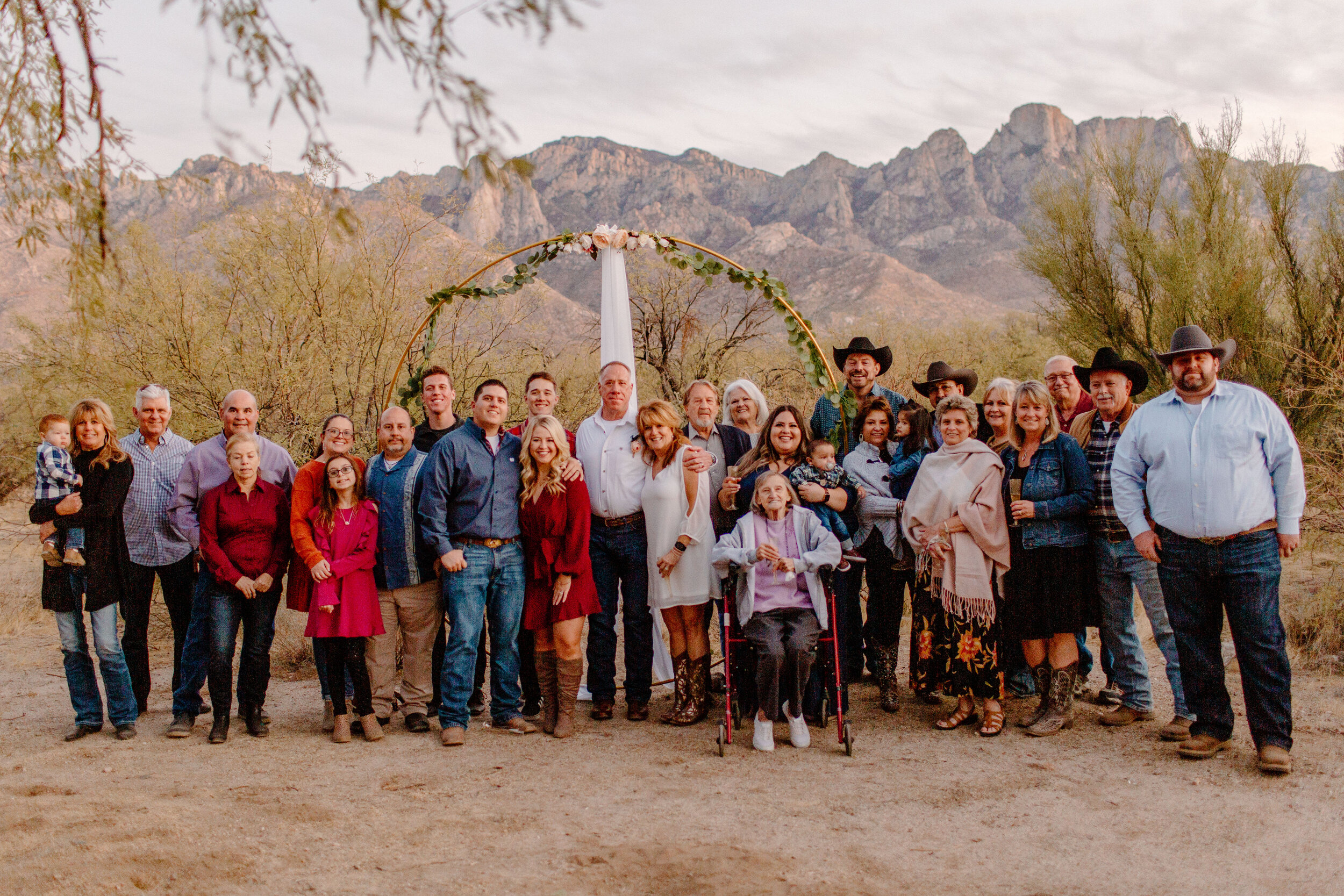 Big group photo of all 25 family and friends with the elopement couple after their ceremony in Catalina State Park in Tucson. Tucson elopement photographer, Lucy B. Photography. 