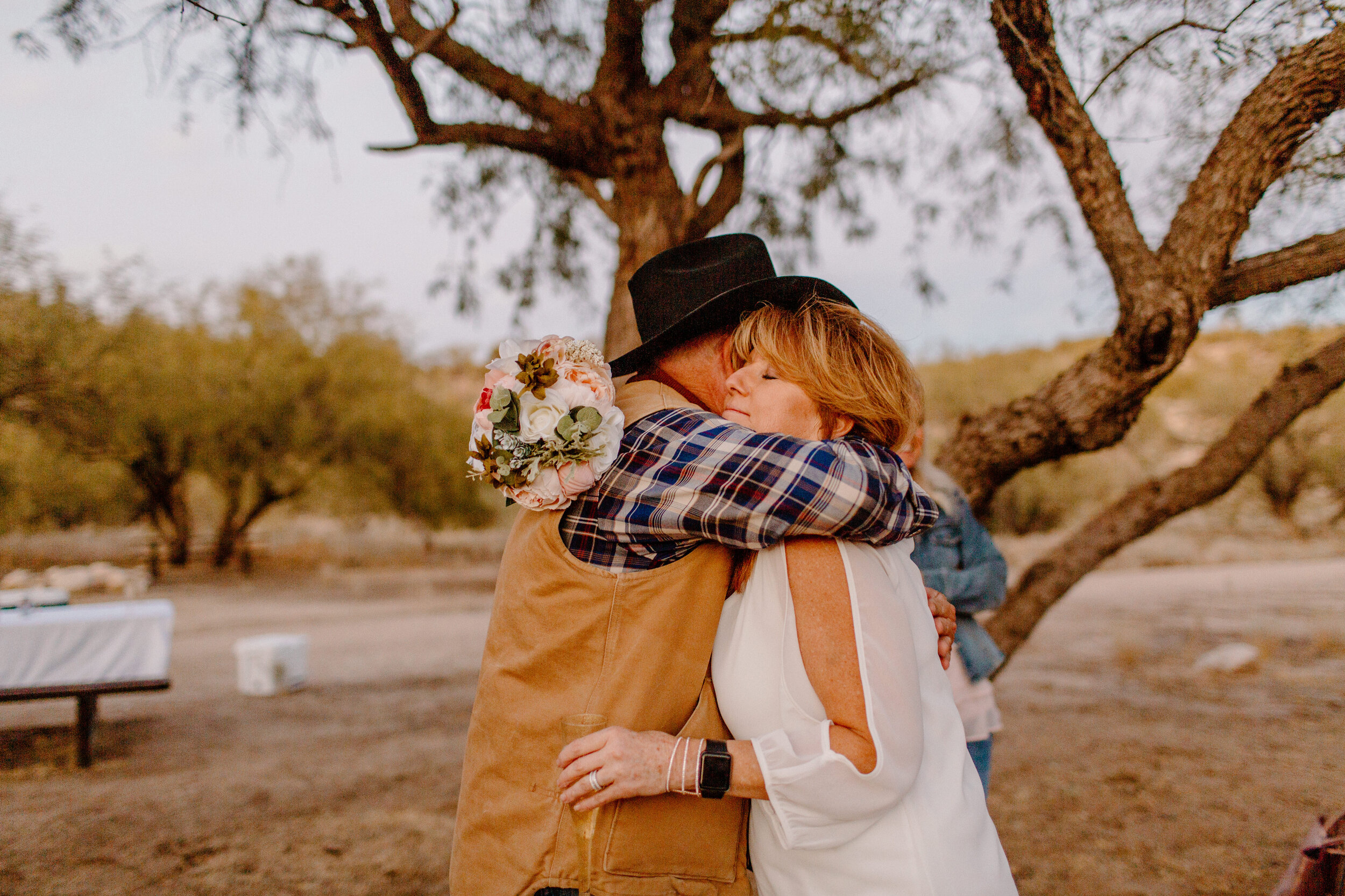  Bride hugs a family member after her elopement ceremony in Catalina State Park in Tucson. Tucson elopement photographer, Lucy B. Photography. 
