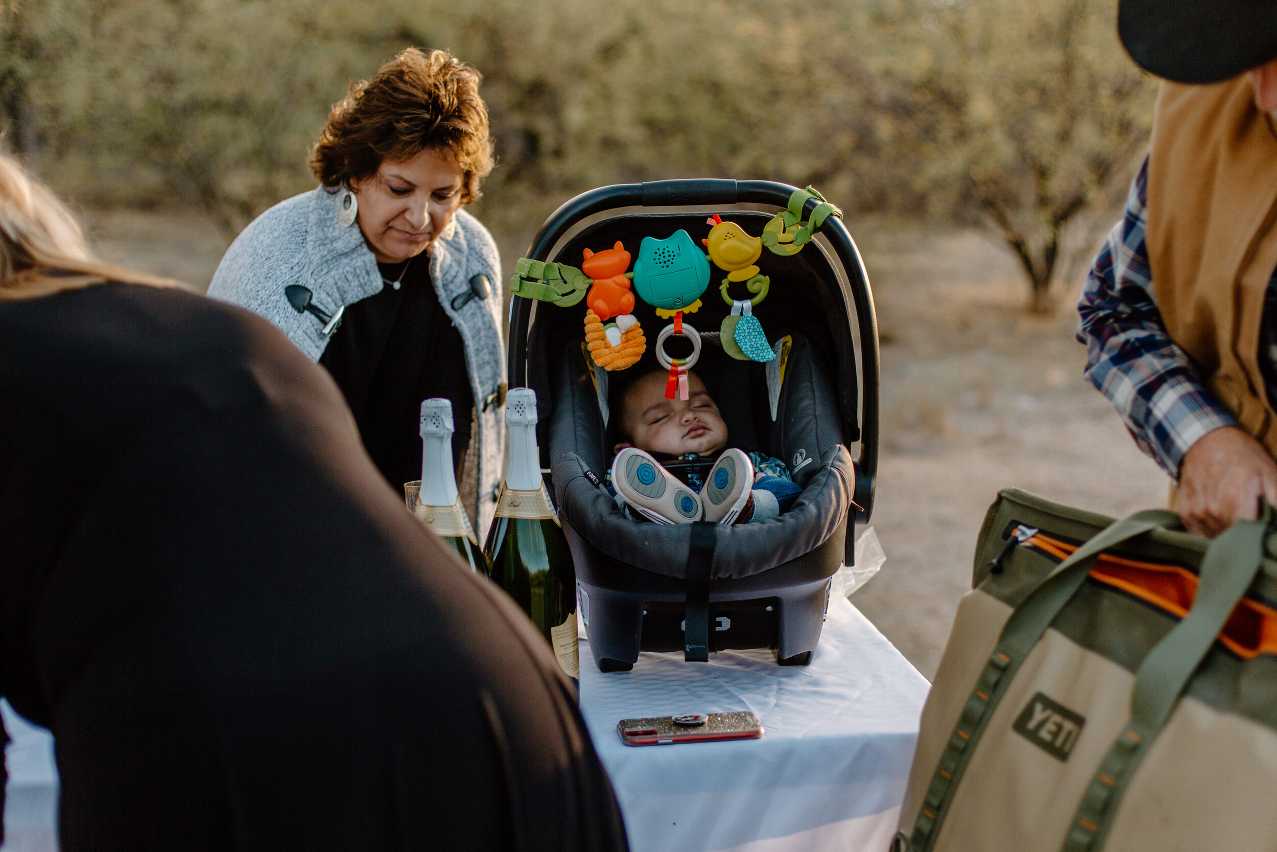  Baby sleeping in car seat while family prepares for an elopement in Catalina State Park in Tucson. Tucson elopement photographer, Lucy B. Photography. 