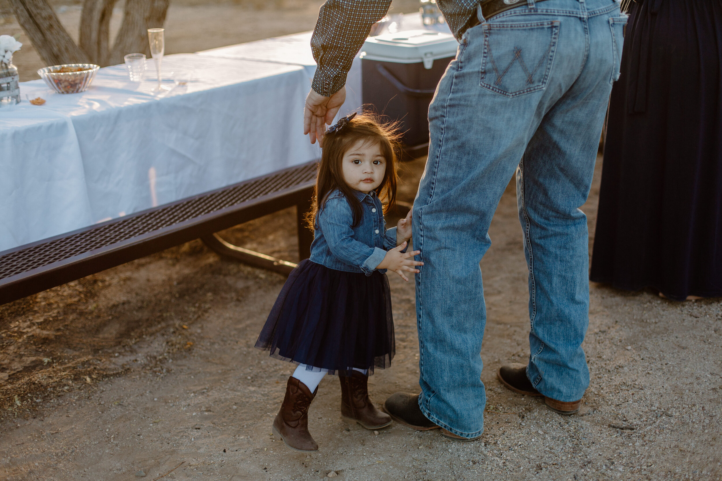  Toddler holds her dad’s leg before an elopement in Catalina State Park in Tucson. Tucson elopement photographer, Lucy B. Photography. 