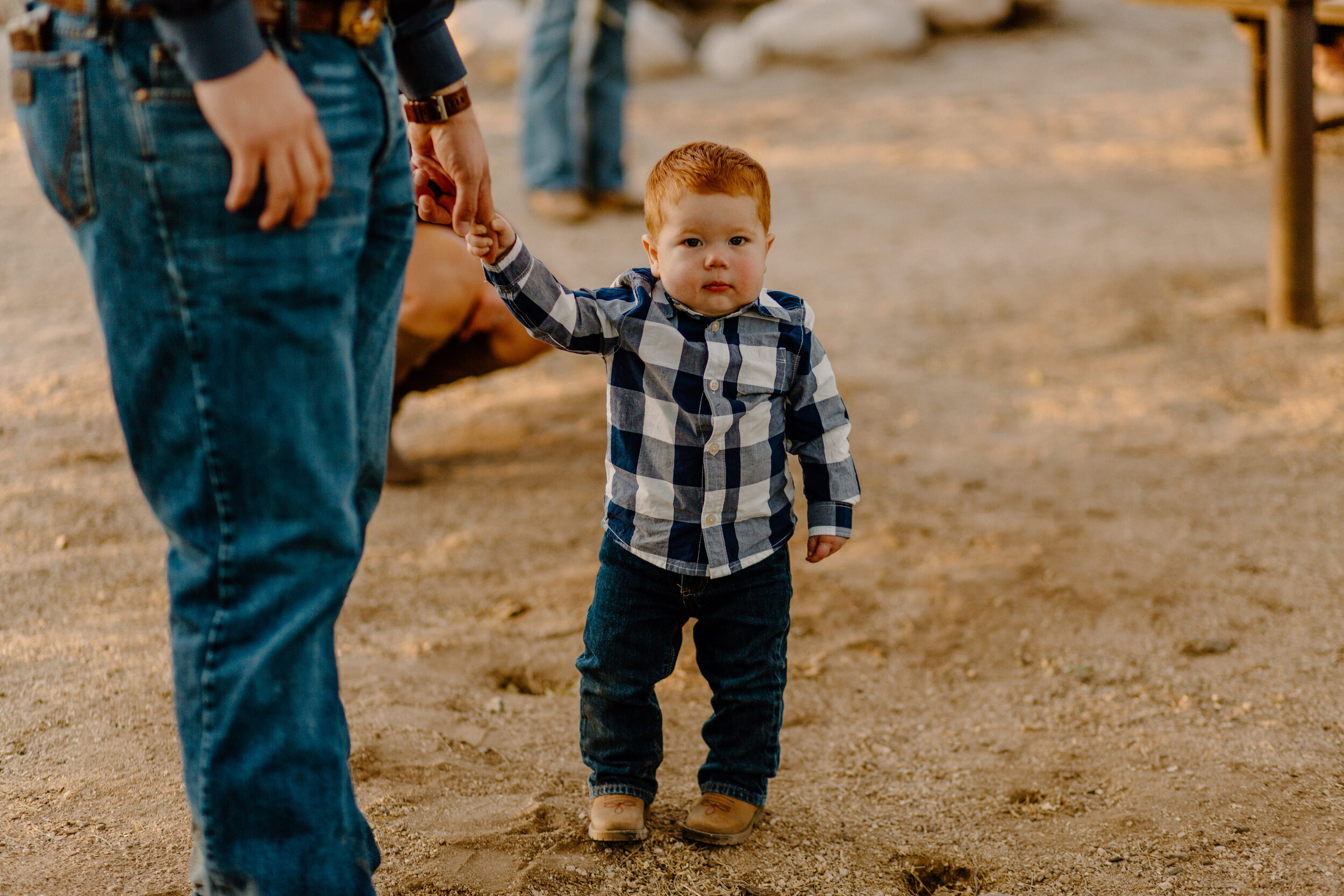  Small toddler holds onto his dad’s finger while waiting for elopement couple in Catalina State Park in Tucson. Tucson elopement photographer, Lucy B. Photography. 