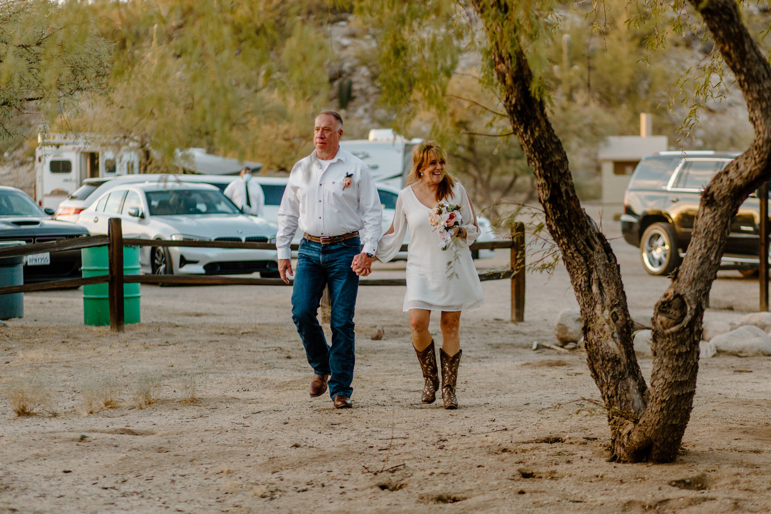  Elopement couple smiles and walks up to their ceremony spot in Catalina State Park in Tucson. Tucson elopement photographer, Lucy B. Photography. 