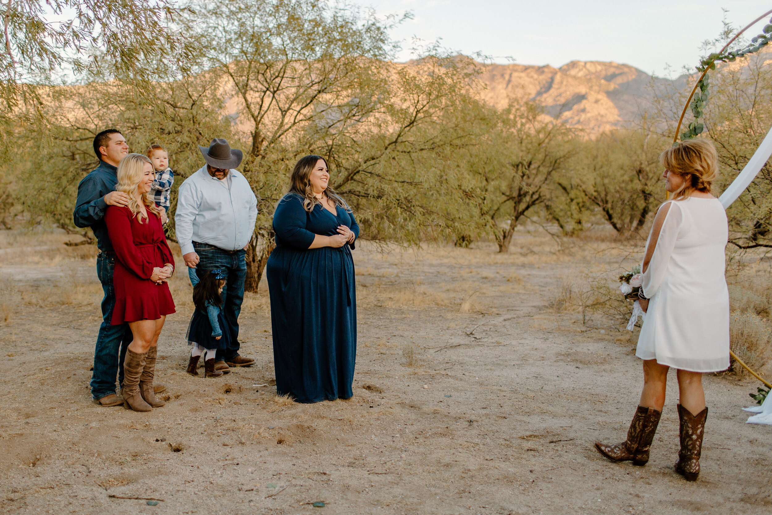  Family watches as elopement couple arrives at their ceremony spot in Catalina State Park in Tucson. Tucson elopement photographer, Lucy B. Photography. 