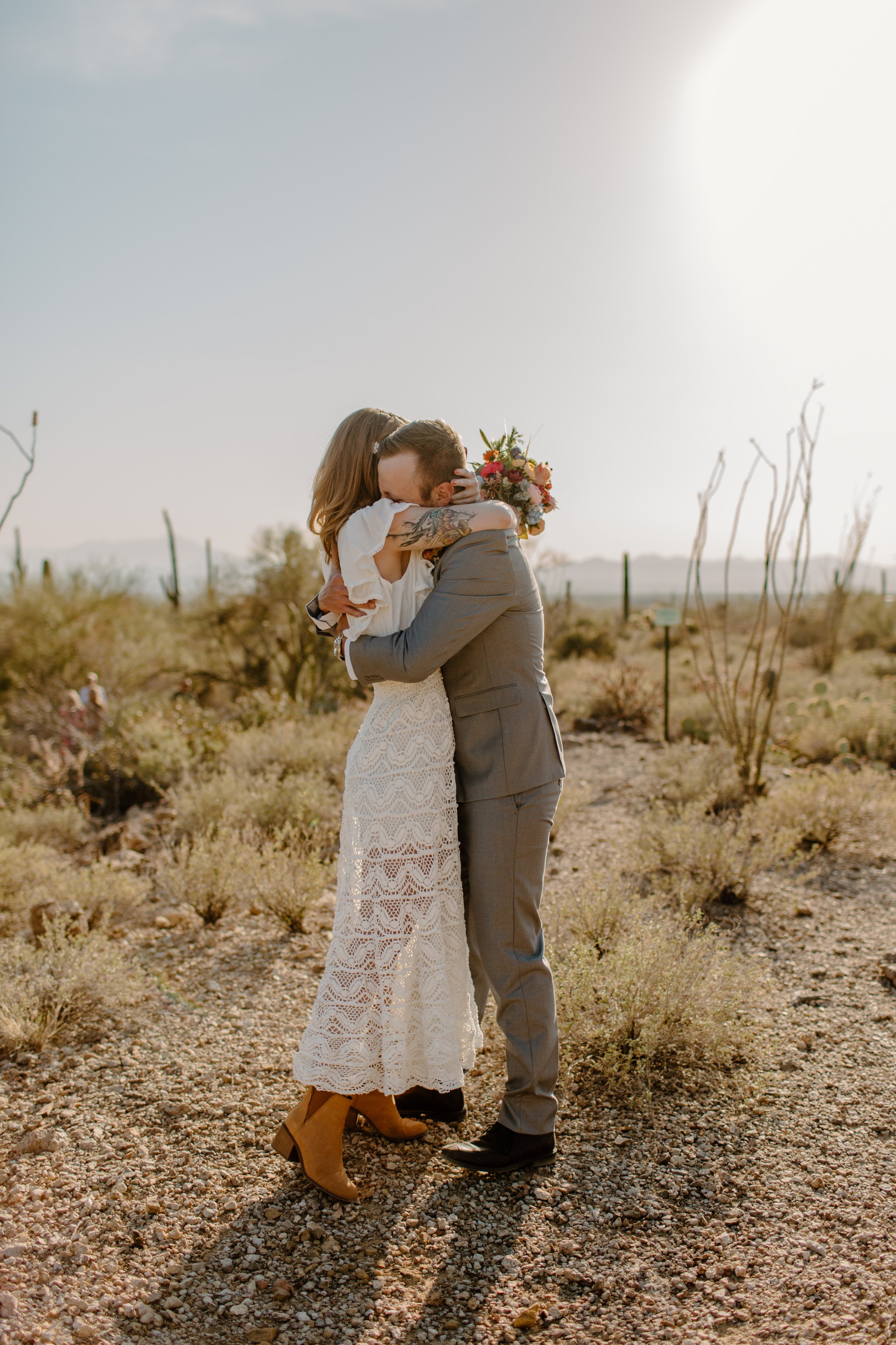  Elopement couple hugs tightly after their first look at Gate’s Pass in the desert of Tucson Arizona 