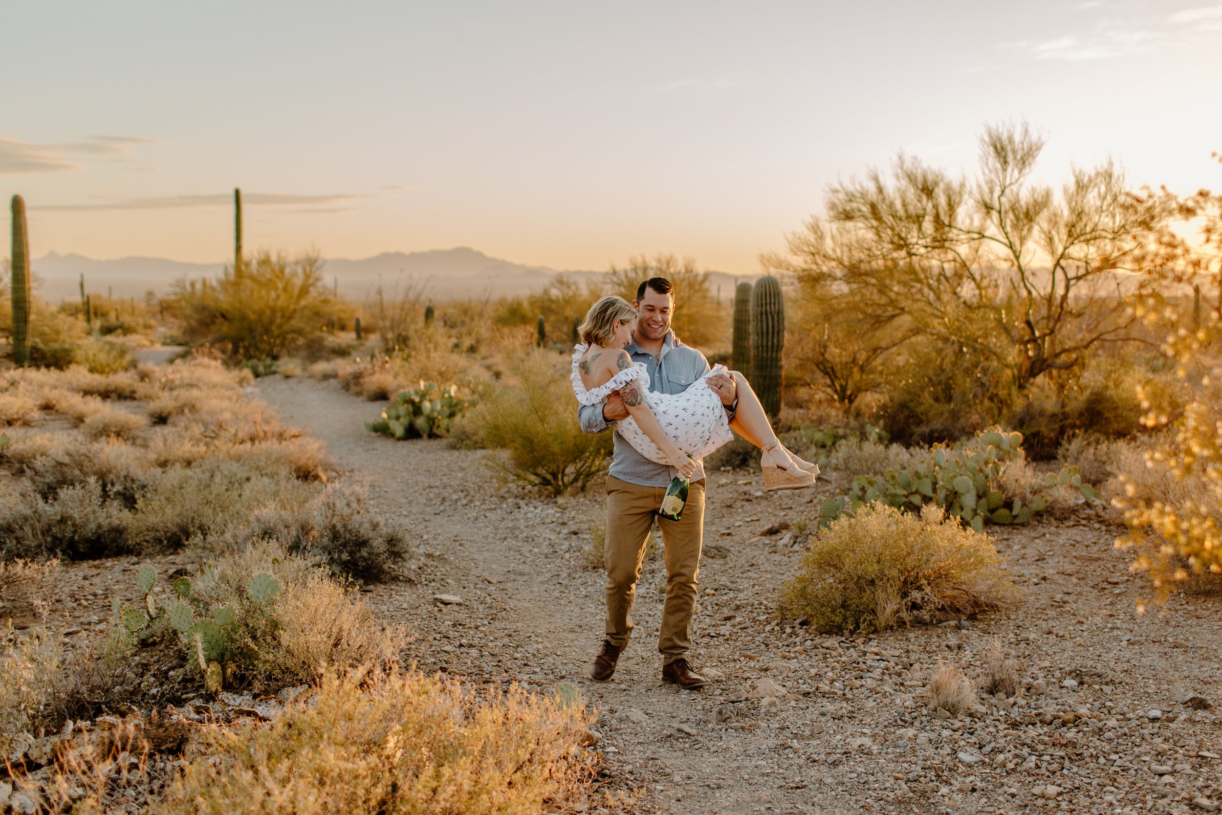 Man carries his wife down a trail in the desert at Gate’s Pass in Tucson Arizona 